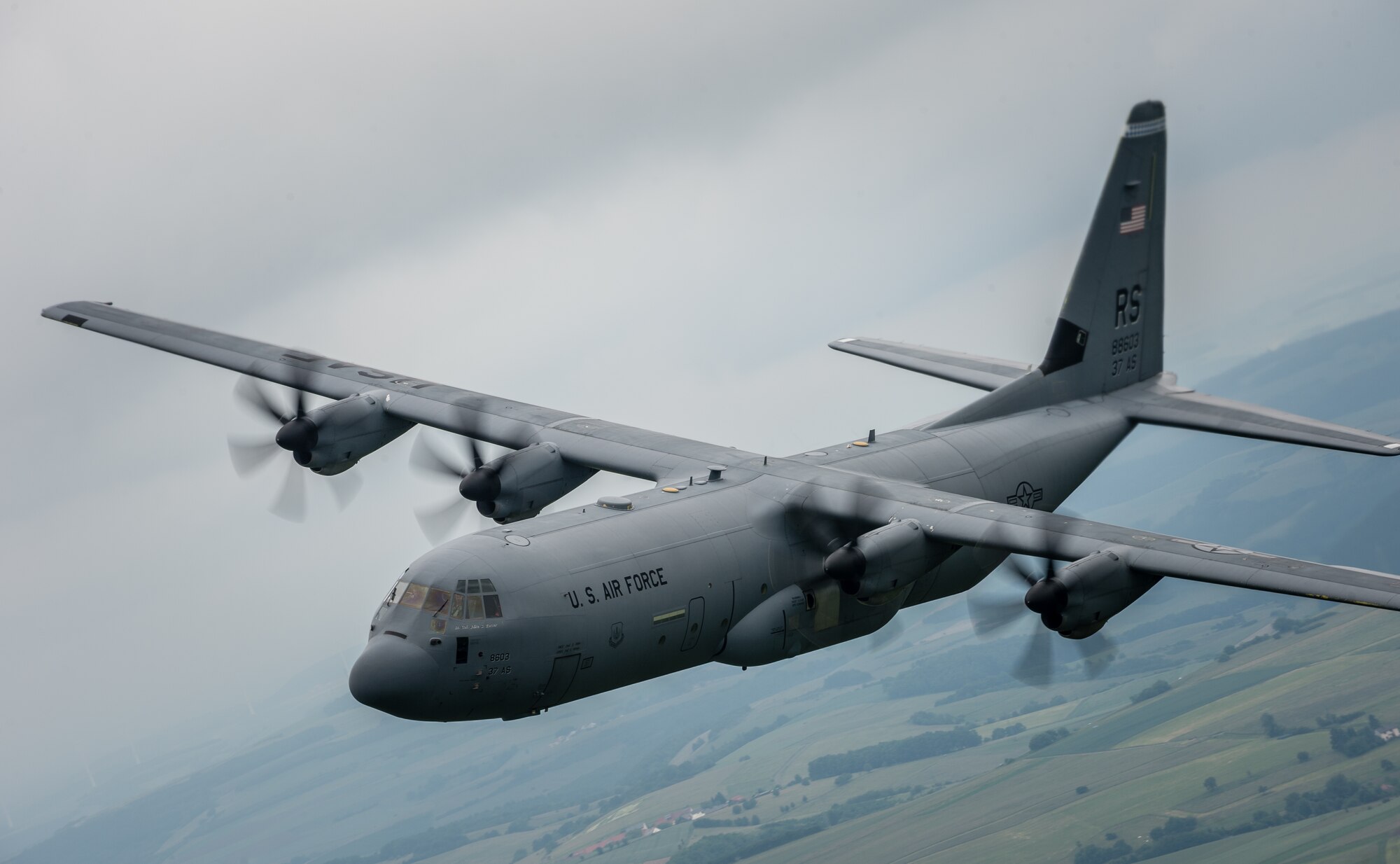 A 37th Airlift Squadron C-130J Super Hercules aircraft practices flying in formation in preparation for events commemorating the 70th anniversary of D-Day in Normandy, over Germany, May 27, 2014. A Douglas C-47 Skytrain, known as Whiskey 7 led the legacy squadron that would become the 37th AS, recently returned to mainland Europe and landed at Ramstein Air Base. The C-47 was assigned to the 37th Troop Carrier Squadron as the lead aircraft for the unit and dropped the 3rd Battalion, 505th Parachute Infantry Regiment, 82nd Airborne Division on Drop Zone "O" near Sainte-Mere Eglise, France. (U.S. Air Force photo/Airman 1st Class Jordan Castelan)