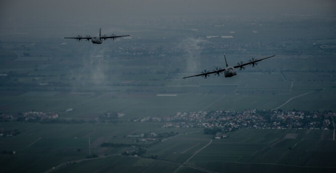 Two 37th Airlift Squadron C-130J Super Hercules aircraft practice flying in formation in preparation for events commemorating the 70th anniversary of D-Day in Normandy, over Germany, May 27, 2014. A Douglas C-47 Skytrain, known as Whiskey 7 led the legacy squadron that would become the 37th AS, recently returned to mainland Europe and landed at Ramstein Air Base. The C-47 was assigned to the 37th Troop Carrier Squadron as the lead aircraft for the unit and dropped the 3rd Battalion, 505th Parachute Infantry Regiment, 82nd Airborne Division on Drop Zone "O" near Sainte-Mere Eglise, France. (U.S. Air Force photo/Airman 1st Class Jordan Castelan)