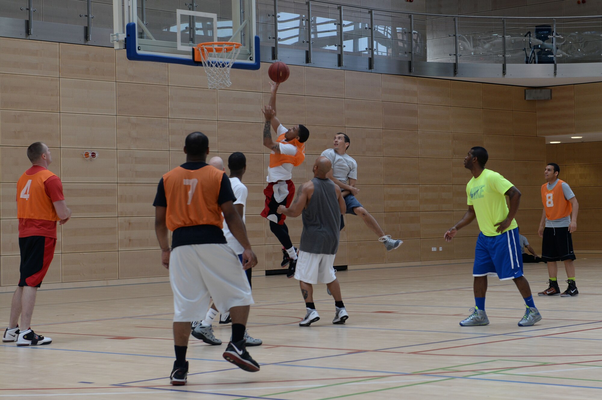 A member from the 606th Air Control Squadron team attempts to score during a wing sports day basketball tournament at Spangdahlem Air Base, Germany, May 29, 2014. Wing sports day kicked off with a wing-wide formation run. (U.S. Air Force photo by Senior Airman Alexis Siekert/Released)