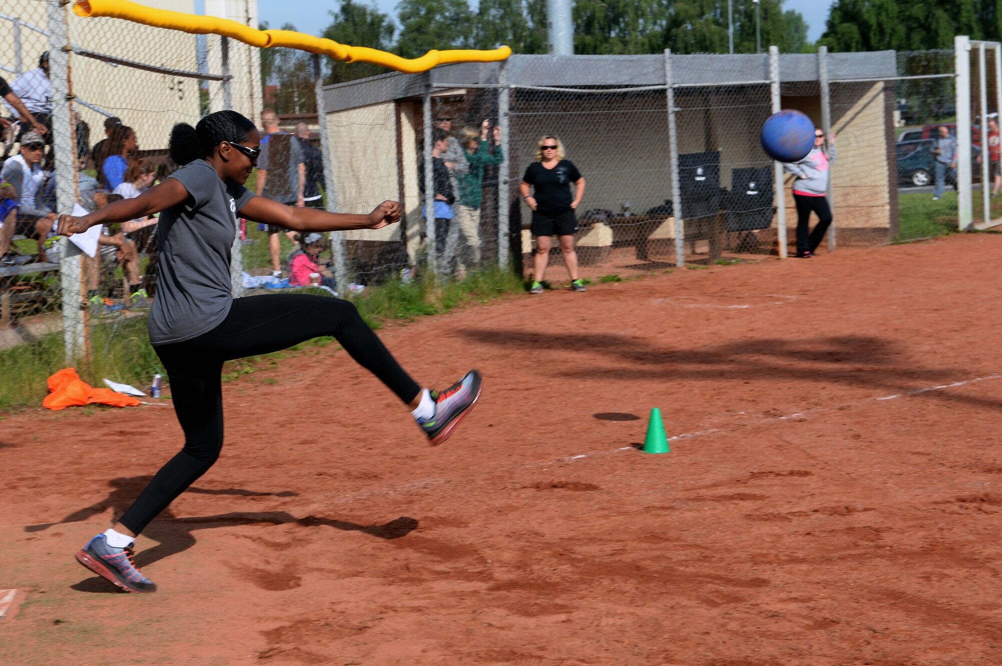 U.S. Air Force Staff Sgt. Imelda Edge, 726th Air Mobility Squadron passenger service supervisor from Houston, drives the ball left during a wing sports day kickball tournament at Spangdahlem Air Base, Germany, May 29, 2014. The base participated in five competitions throughout the day. (U.S. Air Force photo by Senior Airman Alexis Siekert/Released)