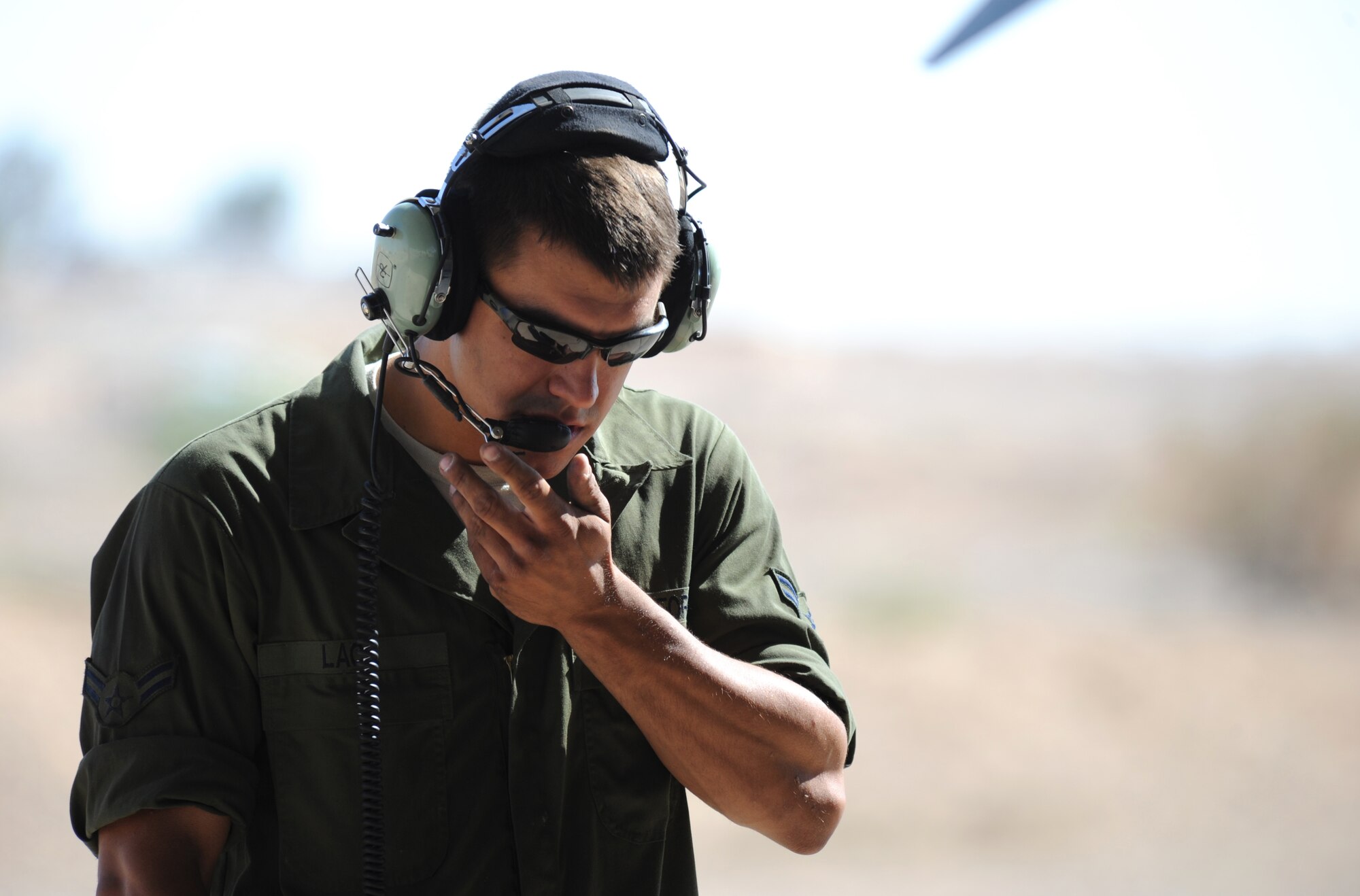 U.S. Air Force Airman 1st Class John Lace, an assistant dedicated crew chief with the 13th Aircraft Maintenance Unit at Misawa Air Base, Japan, communicates with an F-16 Fighting Falcon pilot after a preflight check during Exercise Eager Lion May 27, 2014, at an air base in northern Jordan. Along with crew chiefs, many other maintenance career fields, including avionics, phase and weapons, are responsible for getting the F-16s in the air. This year, more than 12,500 personnel from more than 20 nations are participating in the exercise, which is designed to strengthen military-to-military relationships and interoperability. (U.S. Air Force photo by Staff Sgt. Brigitte N. Brantley/Released)