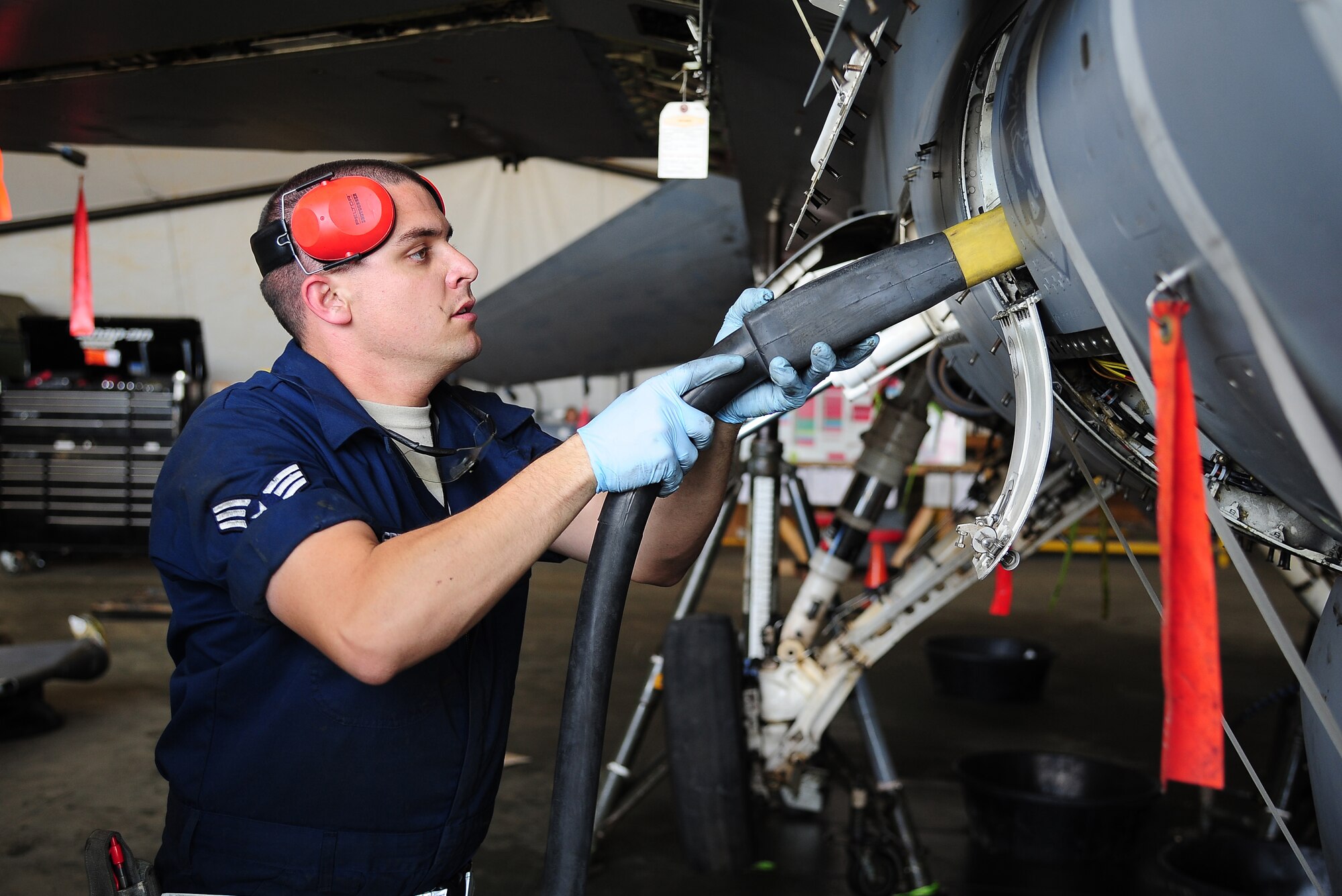 U.S. Air Force Senior Airman Mike Seery, a phase crew chief from the 13th Aircraft Maintenance Unit at Misawa Air Base, Japan, performs routine phase maintenance on an F-16 Fighting Falcon during Exercise Eager Lion May 25, 2014, at an air base in northern Jordan. Every 400 flight hours, F-16s go through phase maintenance to fix and prevent any problems. This year, more than 12,500 personnel from more than 20 nations are participating in the exercise, which is designed to strengthen military-to-military relationships and interoperability. (U.S. Air Force photo by Staff Sgt. Brigitte N. Brantley/Released)