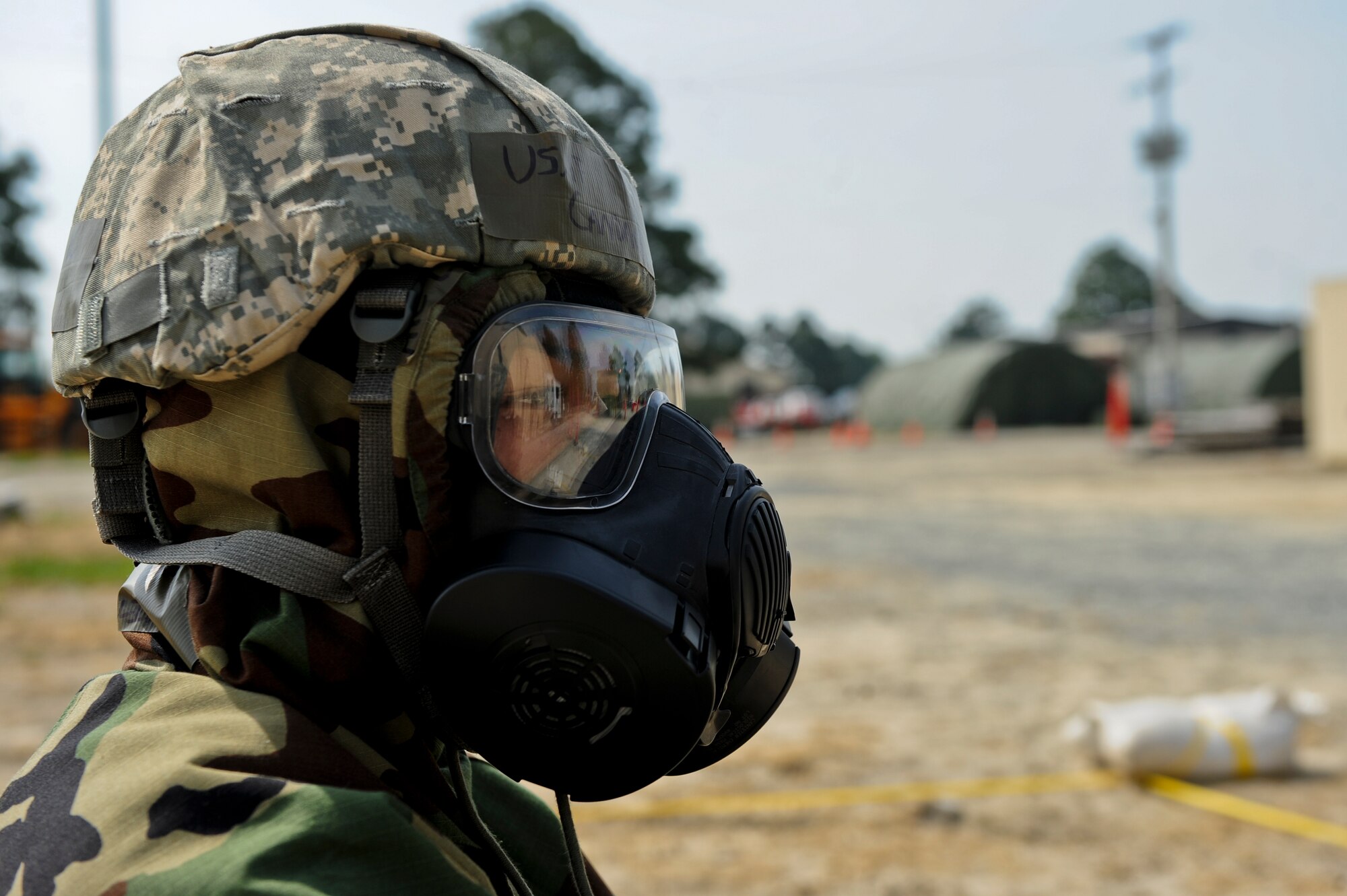 Airman 1st Class Candace Williams, 4th Fighter Wing Public Affairs broadcast journalist, takes cover in a simulated bunker, May 21, 2014, during Employment Exercise CORONET WARRIOR 14-02 at Seymour Johnson Air Force Base, North Carolina.  The exercise assessed Airmen’s readiness and ability to complete missions in a deployed environment.  (U.S Air Force photo/Airman 1st Class Brittain Crolley)  