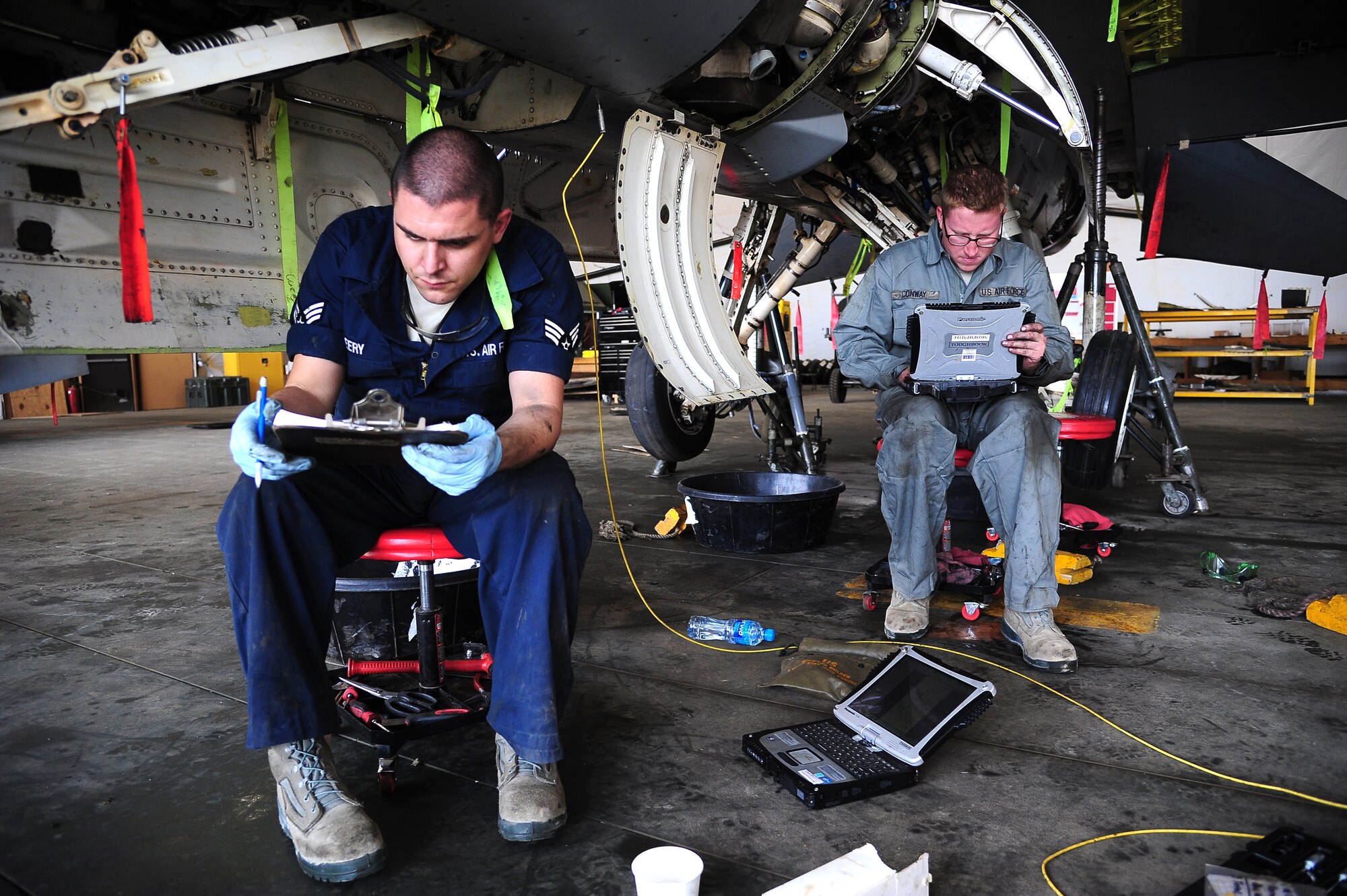 U.S. Air Force Senior Airman Mike Seery, left, reviews checklists while Staff Sgt. Rory Conway checks a technical order during Exercise Eager Lion May 25, 2014, at an air base in northern Jordan. Both phase crew chiefs from the 13th Aircraft Maintenance Unit at Misawa Air Base, Japan, were responsible for ensuring the F-16 Fighting Falcons were flight-ready. This year, more than 12,500 personnel from more than 20 nations are participating in the exercise, which is designed to strengthen military-to-military relationships and interoperability. (U.S. Air Force photo by Staff Sgt. Brigitte N. Brantley/Released)