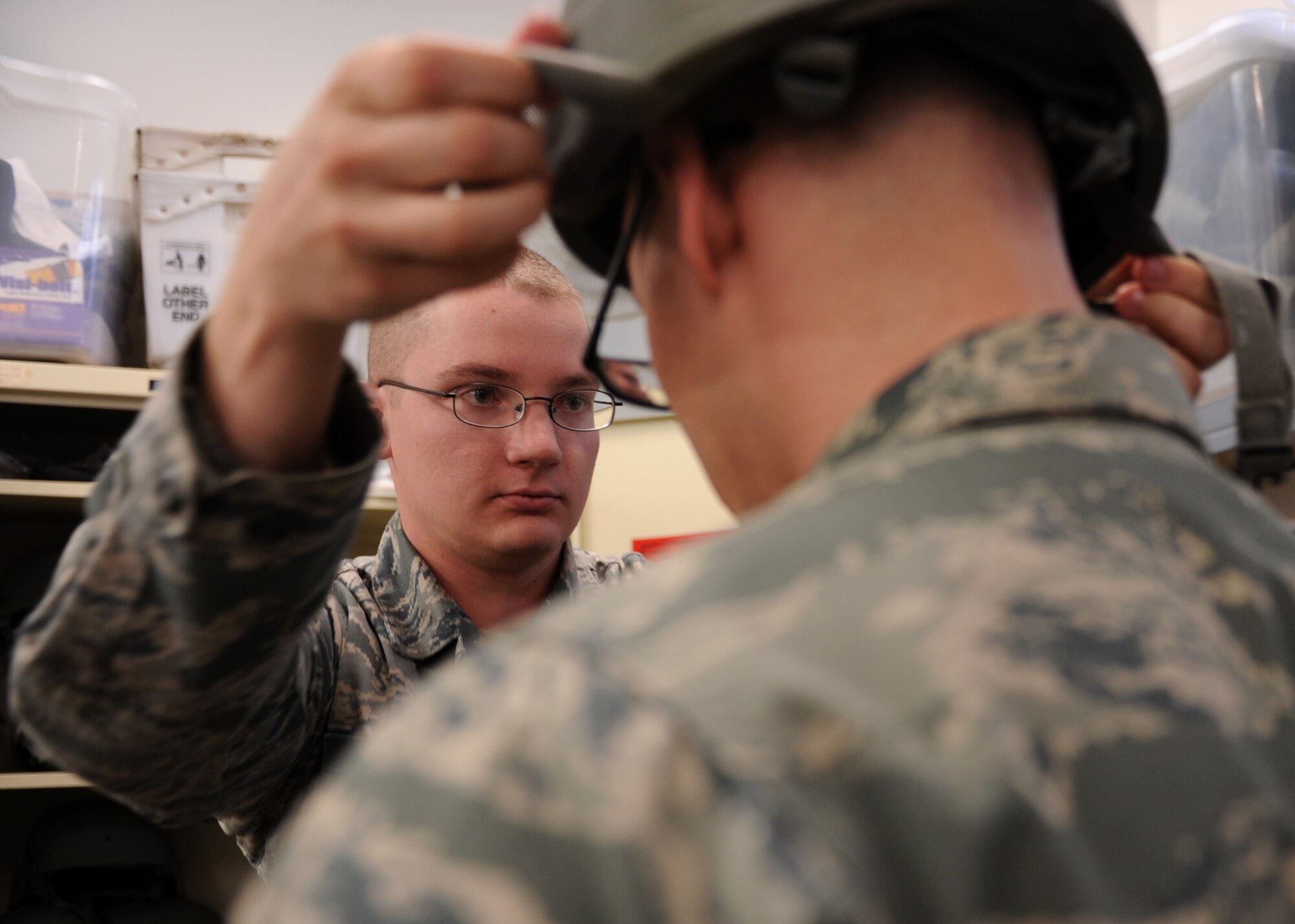 Staff Sgt. Joseph Cross, a 19th Component Maintenance Squadron unit deployment manager, checks the fitting of a helmet May 27, 2014, at Little Rock Air Force Base, Ark. Cross managed his squadron’s foreign object debris program and increased flight availability and participation by 50 percent. (U.S. Air Force photo by Airman 1st Class Scott Poe)
