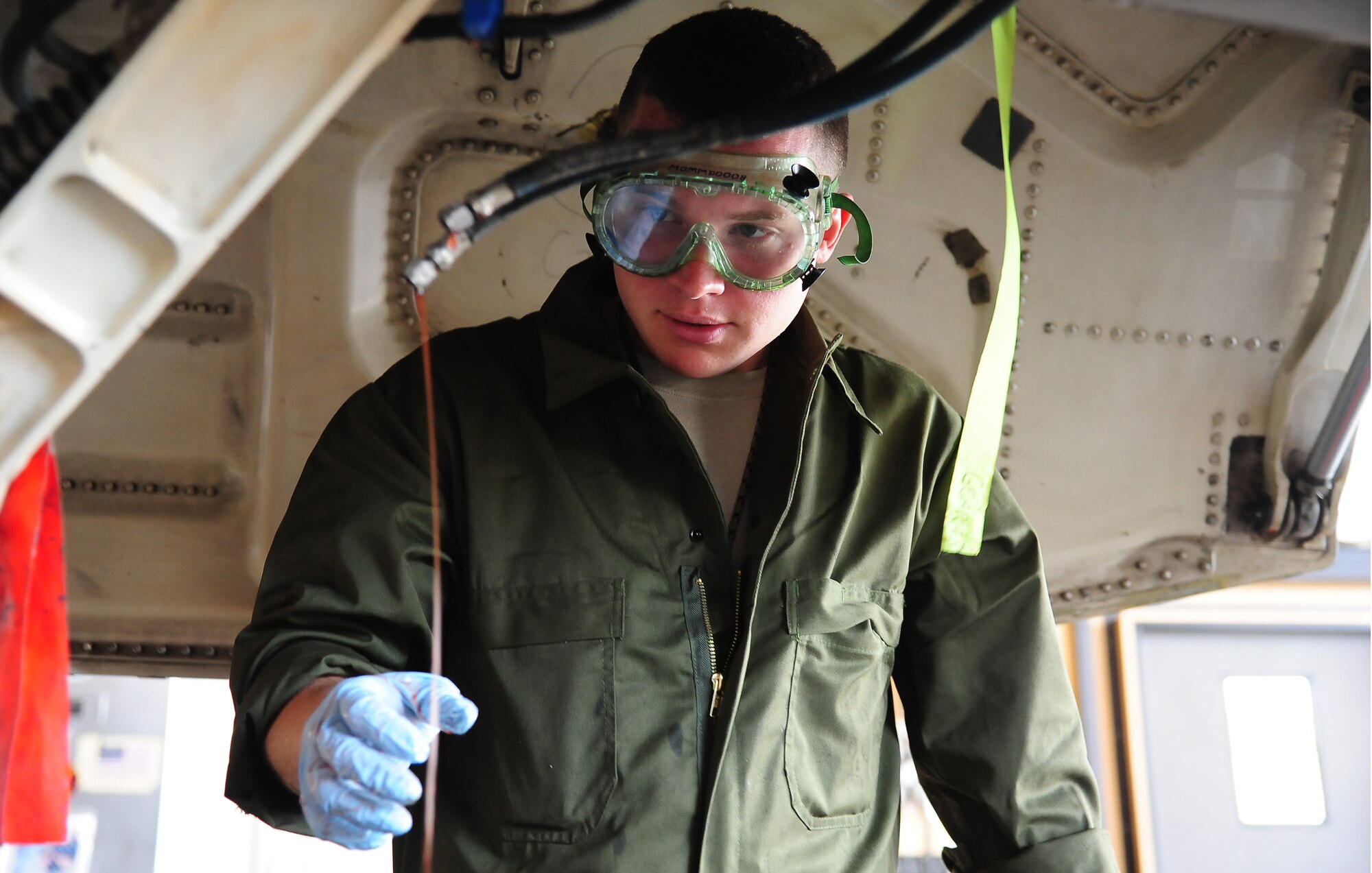 U.S. Air Force Staff Sgt. Joseph Biggs, crash and recovery with the 13th Aircraft Maintenance Unit at Misawa Air Base, Japan, drains hydraulic fluid from an F-16 Fighting Falcon May 25, 2014, during Exercise Eager Lion at an air base in northern Jordan. Aircraft from all branches of the U.S. military flew alongside coalition partners during this annual exercise. This year, more than 12,500 personnel from more than 20 nations are participating in the exercise, which is designed to strengthen military-to-military relationships and interoperability. (U.S. Air Force photo by Staff Sgt. Brigitte N. Brantley/Released)