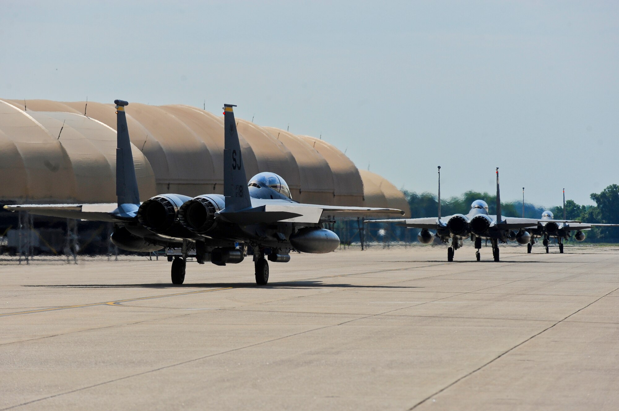 Three F-15E Strike Eagle aircraft taxi to the runway, May 20, 2014, during Employment Exercise CORONET WARRIOR 14-02 at Seymour Johnson Air Force Base, North Carolina.  The exercise tested and prepared Airmen to support overseas contingency operations and effectively complete the mission of the 4th Fighter Wing: to provide Dominant Strike Eagle Airpower, Anytime, Anyplace.  (U.S Air Force photo/Airman 1st Class Brittain Crolley)