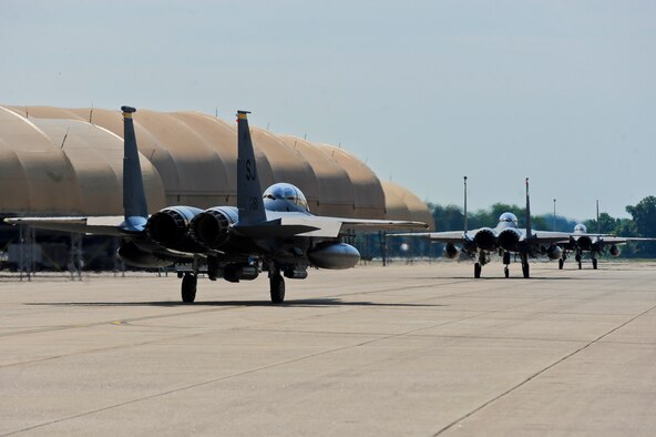 Three F-15E Strike Eagle aircraft taxi to the runway, May 20, 2014, during Employment Exercise CORONET WARRIOR 14-02 at Seymour Johnson Air Force Base, North Carolina.  The exercise tested and prepared Airmen to support overseas contingency operations and effectively complete the mission of the 4th Fighter Wing: to provide Dominant Strike Eagle Airpower, Anytime, Anyplace.  (U.S Air Force photo/Airman 1st Class Brittain Crolley)