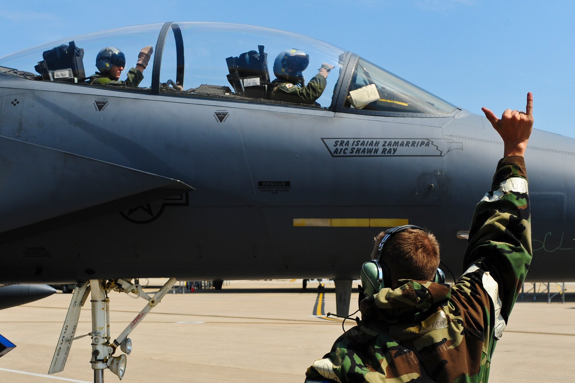 Airman 1st Class Sean Rafferty, 4th Aircraft Maintenance Squadron crew chief, signals to outbound aircrew in an F-15E Strike Eagle aircraft, May 20, 2014, during Employment Exercise CORONET WARRIOR 14-02 at Seymour Johnson Air Force Base, North Carolina. During the training exercise, maintenance personnel were tested on their ability to generate aircraft for takeoff during fluctuating force protection conditions. (U.S. Air Force photo/Airman 1st Class Brittain Crolley)