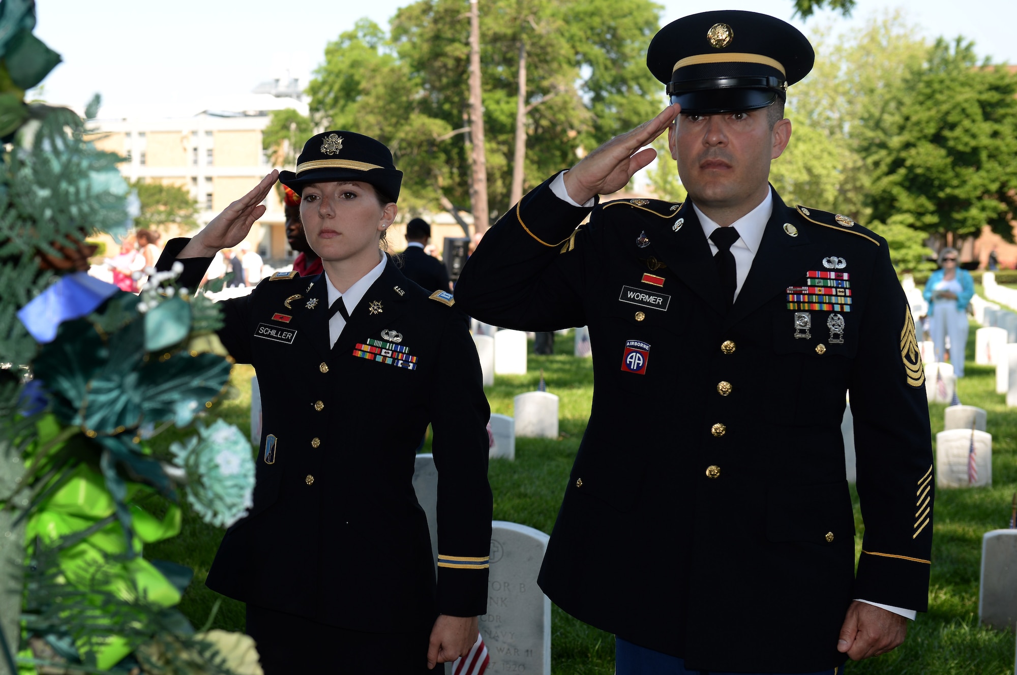 From left, U.S. Army Capt. Emma Schiller, Headquarters and Headquarters Company, Training and Doctrine Command company commander, and 1st Sgt. Chadwick Warner, HHC, TRADOC first sergeant, salute a ceremonial wreath during a Memorial Day ceremony in Hampton, Va., May 26, 2014. On Memorial Day, ceremonies are held at over 130 national cemeteries and 33 Soldiers’ lots and monument sites (U.S. Air Force photo by Senior Airman Teresa J.C. Aber/Released)