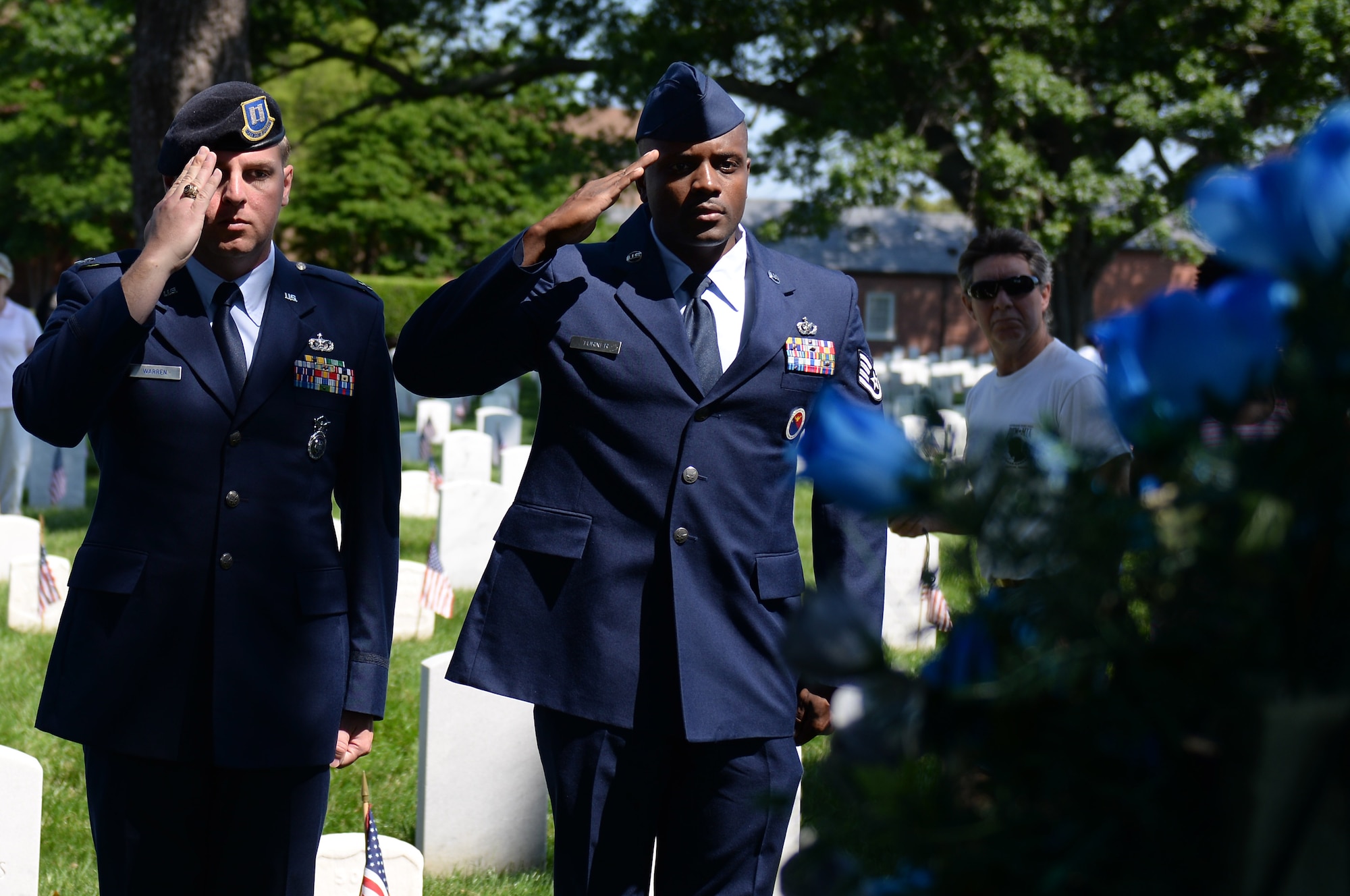 U.S. Air Force Capt. Michael Warren, 633rd Security Forces Squadron operations officer, and Staff Sgt. Damar Turner, 633rd Force Support Squadron Airman Leadership School instructor, salute a ceremonial wreath during a Memorial Day ceremony in Hampton, Va., May 26, 2014. Representatives from each branch of the military laid wreaths in honor of members of their respective branches of service who made the ultimate sacrifice in service to the nation. (U.S. Air Force photo by Senior Airman Teresa J.C. Aber/Released)