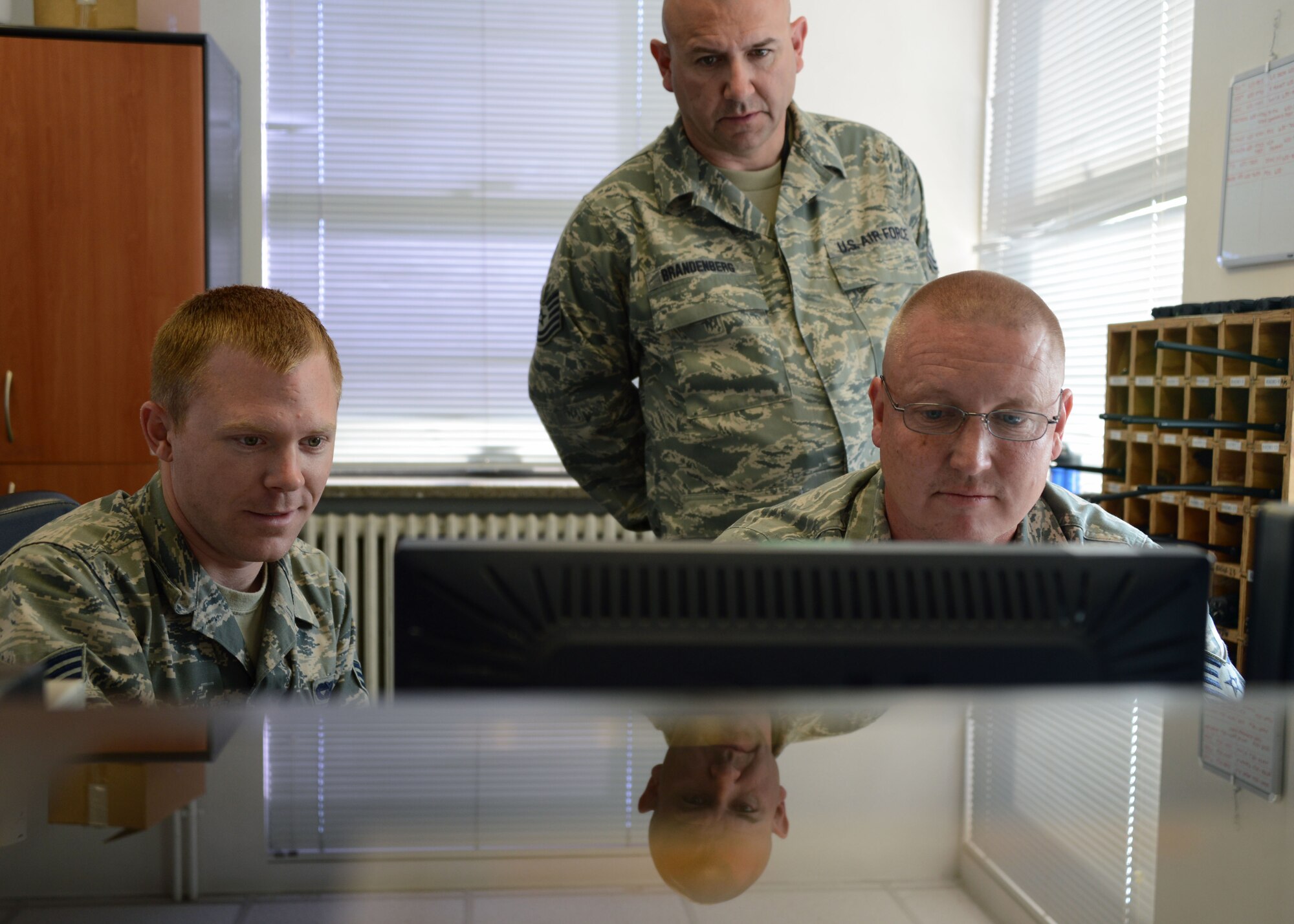 U.S. Air Force Senior Airman Aaron Cresson, a vehicle operator/dispatcher with the 31st Logistics Readiness Squadron, trains Tech. Sgts. Tracy Brandenburg and Richard Malloy on the Online Vehicle Interactive Management System, May 29, 2014 at Aviano Air Base, Italy. Brandenburg and Malloy, vehicle operators for the 175th Logistics Readiness Squadron, were part of the nearly 50 members of the Maryland National Guard deployed to Italy to train with their active duty counterparts. (National Guard photo by 2nd Lt. Benjamin Hughes)