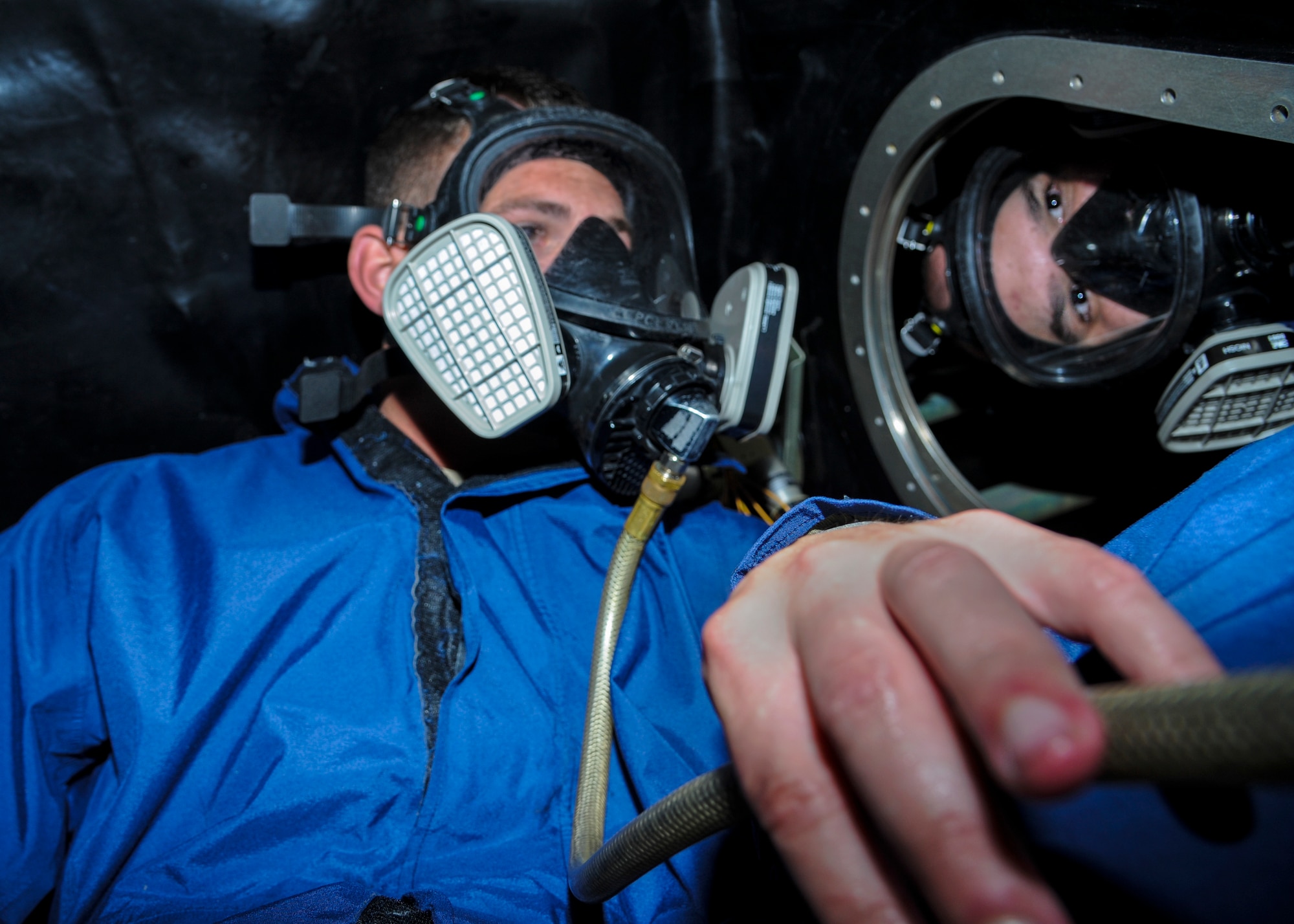 Senior Airman Taylor Weishaar, a 19th Maintenance Group fuels system repair technician, looks for corrosion or deterioration on the inside of a fuel tank May 27, 2014, at Little Rock Air Force Base, Ark. Even when empty, the air inside fuel tanks can be harmful, so respirators are required. (U.S. Air Force photo by Airman 1st Class Harry Brexel)