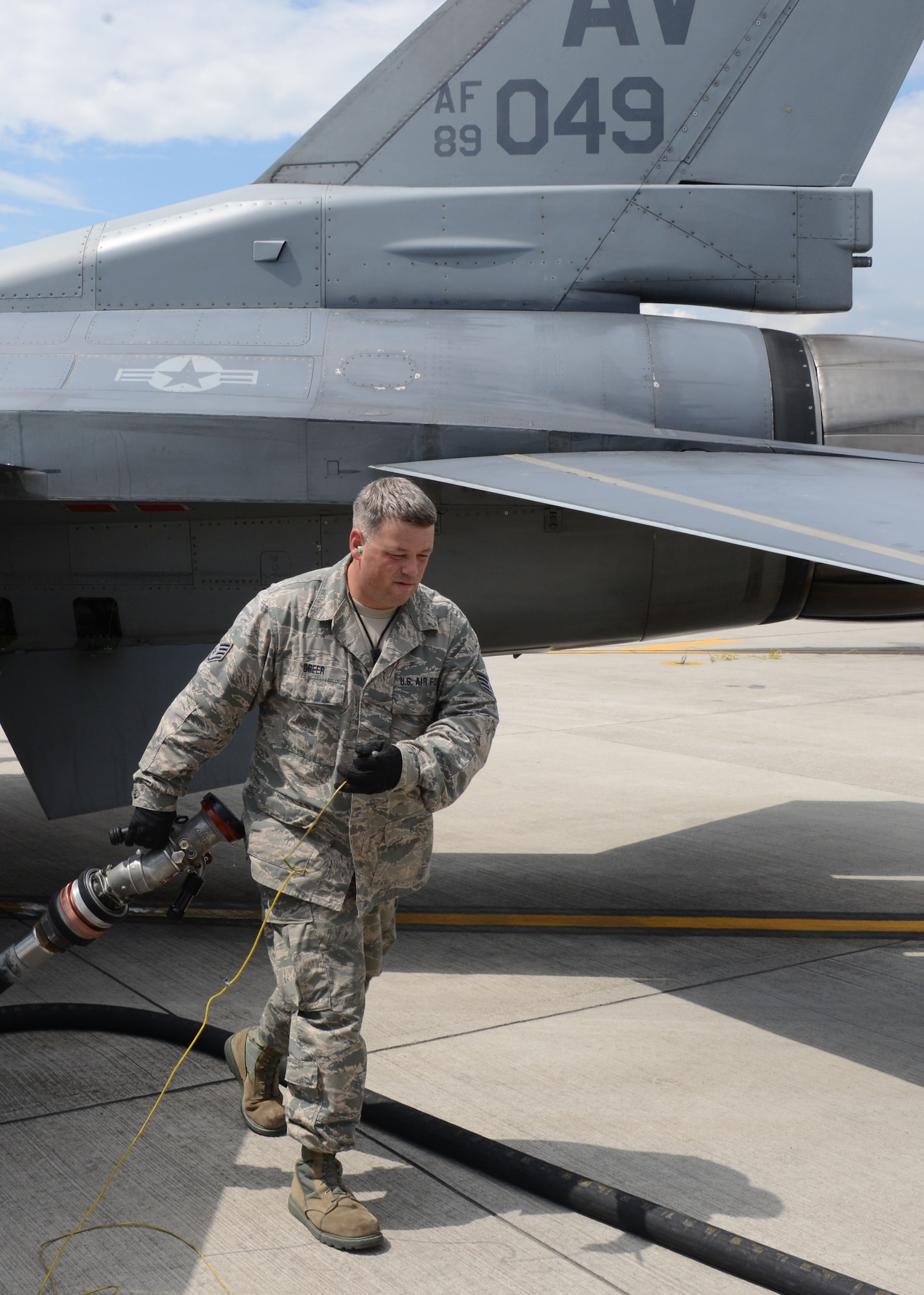 Staff Sgt. Kelly Greer, from the 175th Fuel Management flight, prepares to refuel an F-16 Fighting Falcon, May 29, 2014 at Aviano Air Base, Italy. Nearly 50 members of the Maryland Air National Guard deployed to Italy to train with their active duty counterparts.  (National Guard photo by Master Sgt. Gareth Buckland/Released)