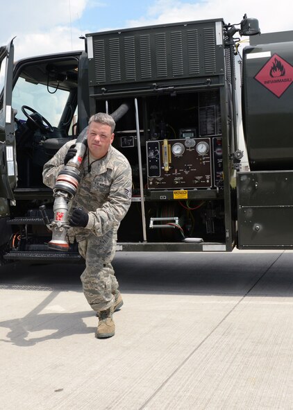 Staff Sgt. Kelly Greer, from the 175th Fuel Management flight, prepares to refuel an F-16 Fighting Falcon, May 29, 2014 at Aviano Air Base, Italy. Nearly 50 members of the Maryland Air National Guard deployed to Italy to train with their active duty counterparts.  (National Guard photo by Master Sgt. Gareth Buckland/Released)