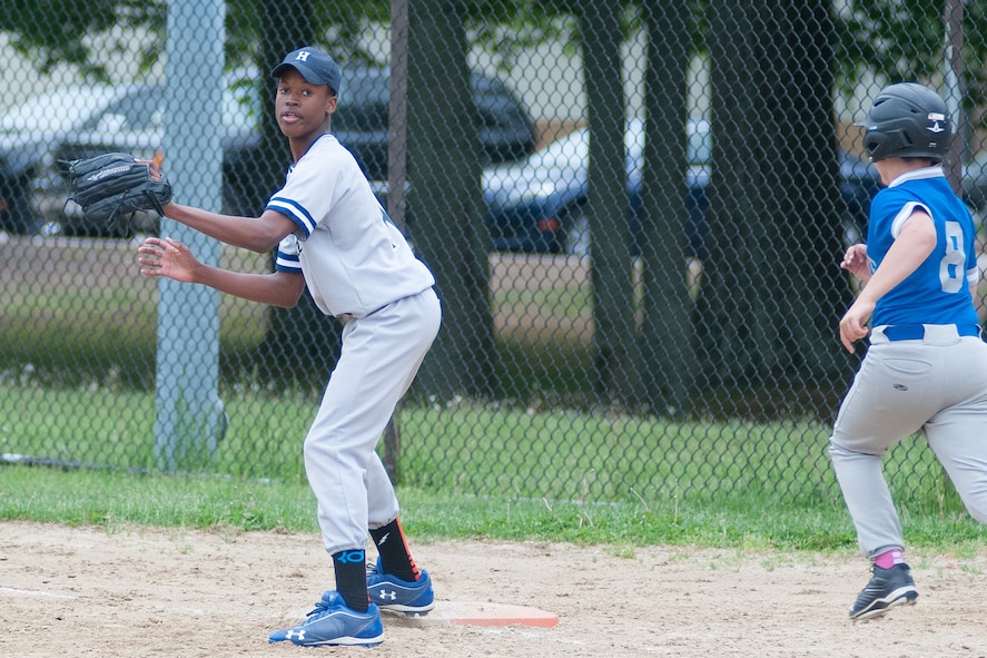 HANSCOM AIR FORCE BASE, Mass. -- Sam Baker, a member of the Hansom Middle School Falcons boy’s baseball team, makes the play at first base for an out during the team’s final home game of the season against Lexington Clarke Middle School May 27. The Falcons lost the game 14-7 to drop to 1-8 on the season. The team’s one win, the first in three years, came against Lincoln May 15. (U.S. Air Force photo by Mark Herlihy)