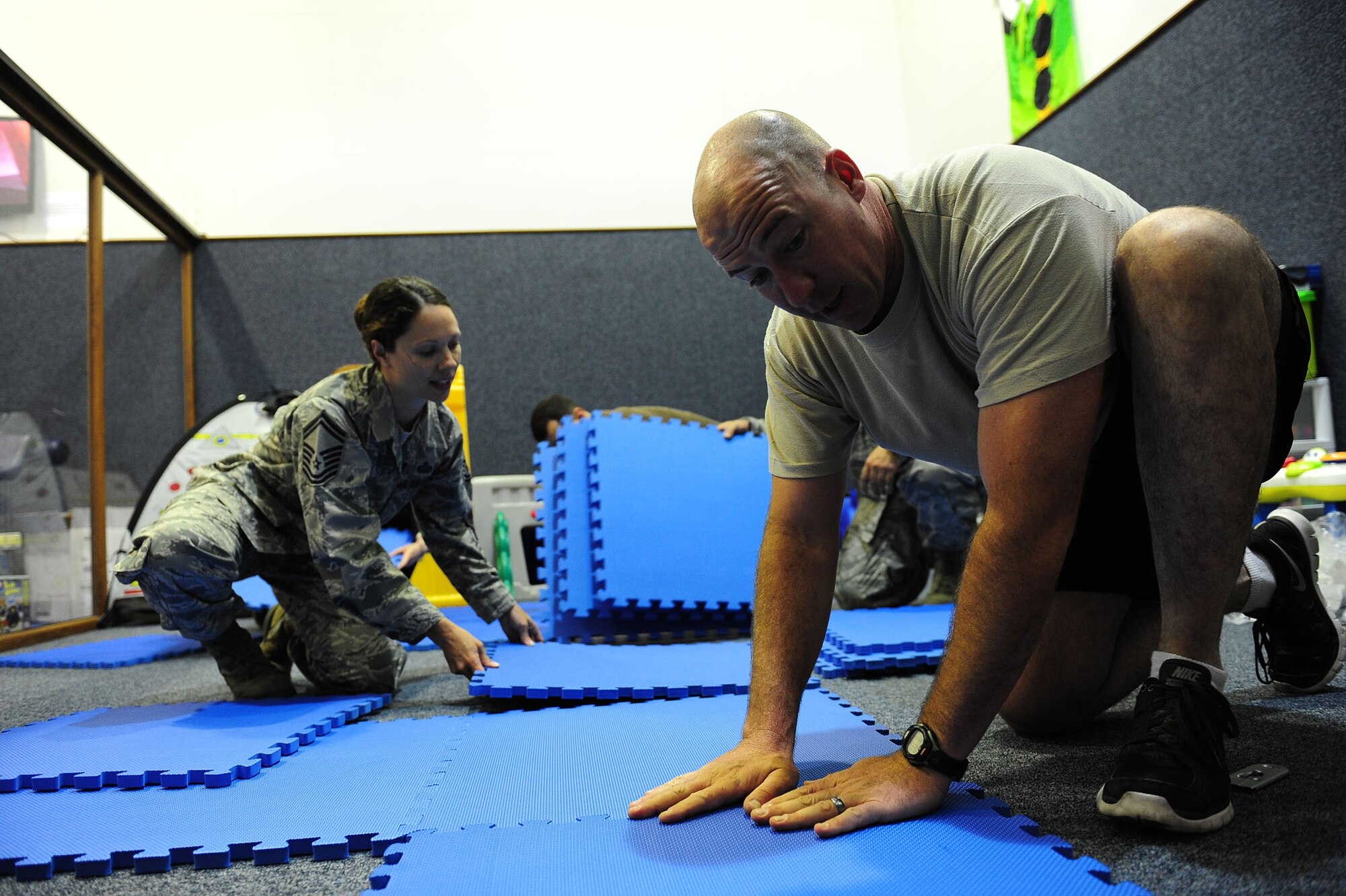Senior Master Sgt. Trisha Malec, 39th Force Support Squadron superintendent and Master Sgt. Jason Chiasson, 728th Air Mobility Squadron first sergeant, place new toys in the play area May 14, 2014, Incirlik Air Base, Turkey. The goal of this project is to make the area a fun place for children to come and play, allowing military and dependent parents the opportunity to work out without having to secure daycare for their children. (U.S. Air Force photo by Senior Airman Nicole Sikorski/Released) 