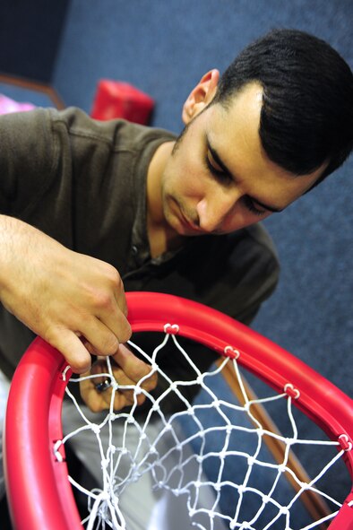 Joe Dyson, 39th Force Support Squadron sustainment services flight chief, assembles a basketball net May 14, 2014, Incirlik Air Base, Turkey.  The Incirlik Air Base First Sergeants council came together to modernize and improve the children’s play area at the fitness center. (U.S. Air Force photo by Senior Airman Nicole Sikorski/Released) 