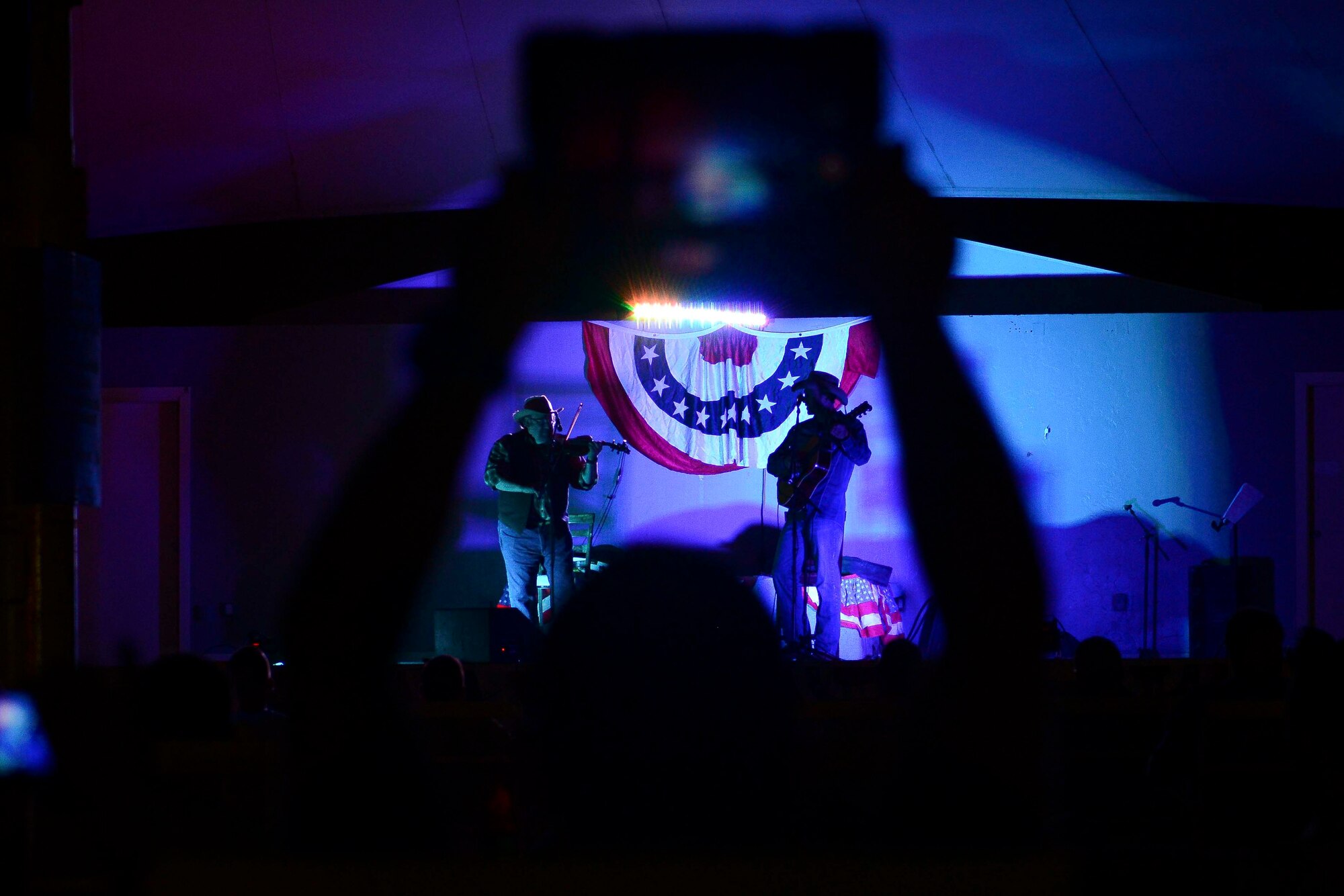 An Airman records a performance by Charlie Zahm at Al Udeid Air Base, Qatar, May 26, 2014. Zahm performed as part of celebration for Memorial Day. The country music star performed for Grand Slam warriors as part of the wing’s celebrations for Memorial Day. (U.S. Air Force photo by Staff Sgt. Ciara Wymbs)