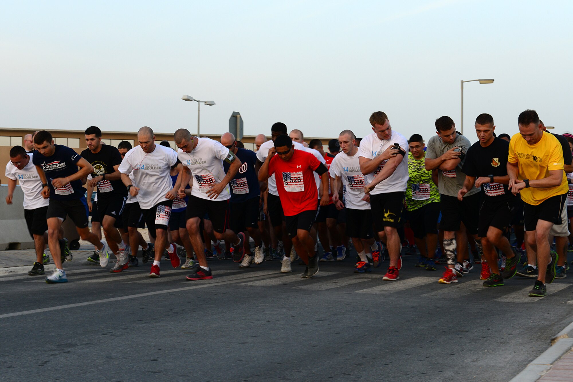 U.S. Air Force Airmen assigned to the 379th Air Expeditionary Wing start a Memorial Day 10K run at Al Udeid Air Base, Qatar, May 26, 2014. The event was part of a host of wing-wide activities in celebration of Memorial Day. (U.S. Air Force photo by Staff Sgt. Ciara Wymbs)