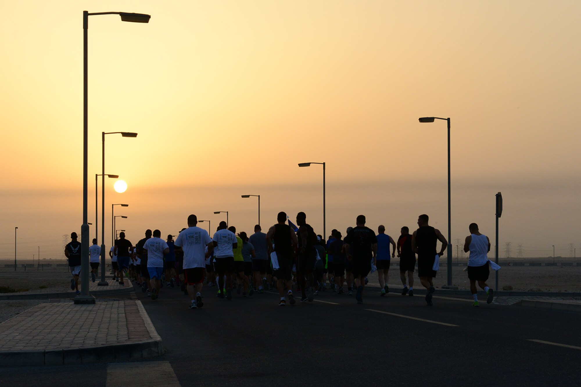 U.S. Air Force Airmen assigned to the 379th Air Expeditionary Wing participate in a Memorial Day 10K run at Al Udeid Air Base. Qatar, May 26, 2014. The run was part of a host of wing-wide activities in celebration of Memorial Day. (U.S. Air Force photo by Staff Sgt. Ciara Wymbs) 