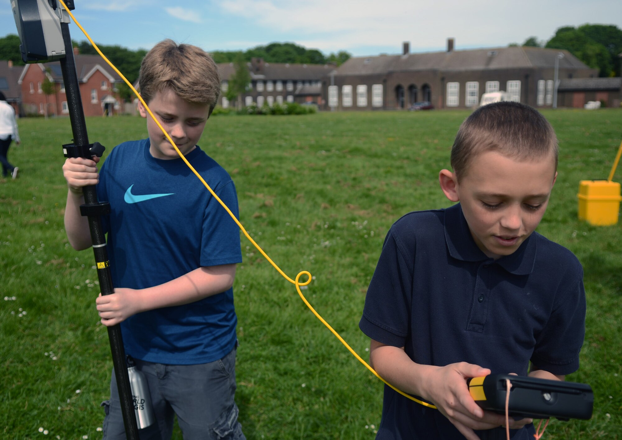 Jackson Karwoski, left, son of Margaret Daniels-Karwoski, a teacher at Feltwell Elementary School; and Pedro Lender, son of Tech. Sgt. Jeffery Eriksson, 748th Aircraft Maintenance Squadron, RAF Lakenheath, England, use a Trimble R8 GPS to locate an object during a Geographic Information System Day May 21, 2014, at Lakenheath Middle School on RAF Feltwell, England. The system collects information from various satellite systems for a more accurate location. (U.S. Air Force photo by Airman 1st Class Kyla Gifford/Released)
