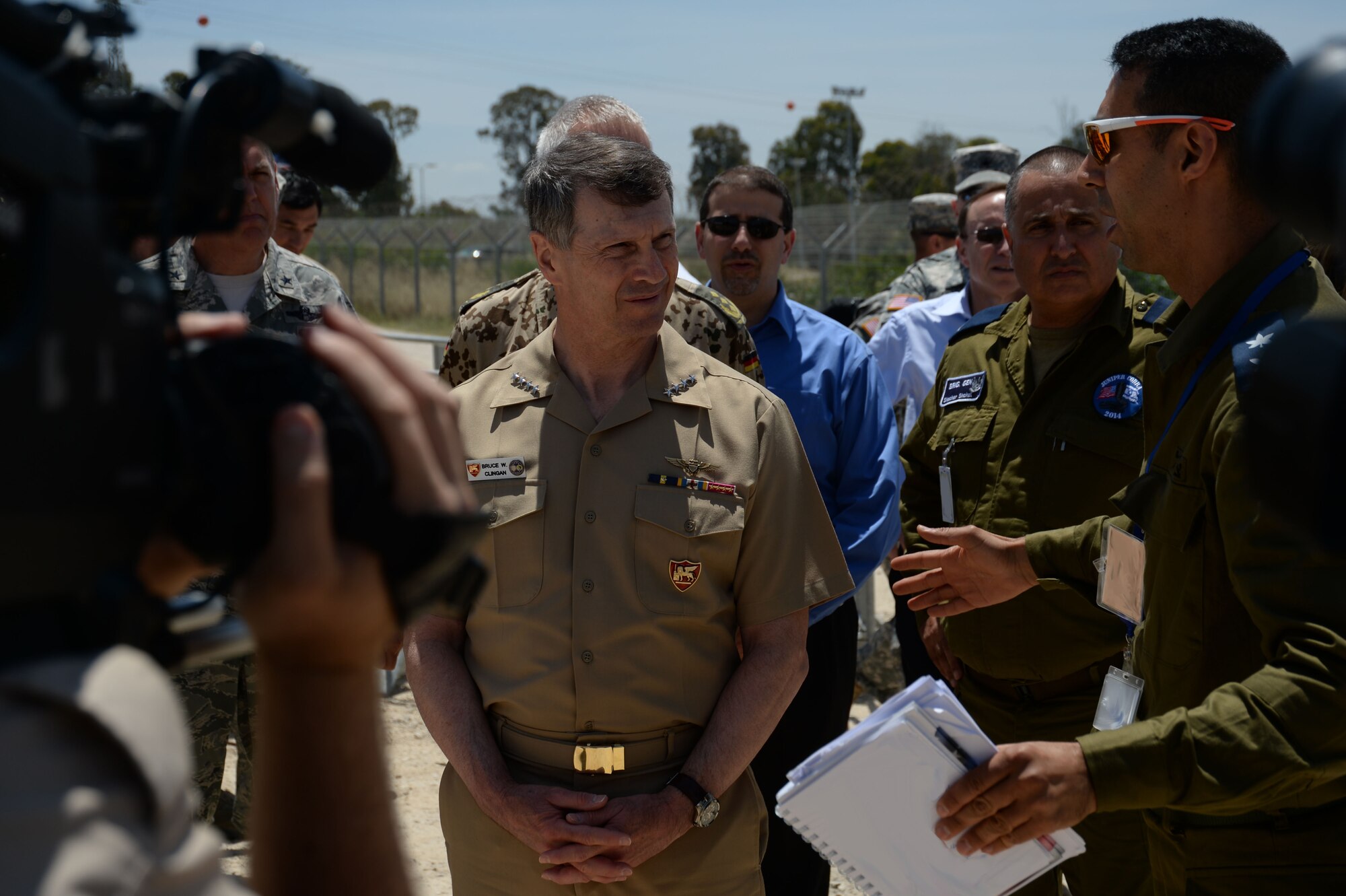 U.S. Navy Adm. Bruce W. Clingan, commander of U.S. Naval Forces Europe, center, listens to a presentation by an Israeli Defense Forces service member during a tour of Hatzor Air Base, Israel, May 19, 2014. The admiral toured the installation to oversee the progress of Juniper Cobra 14, a bilateral defense exercise. (U.S. Air Force photo illustration by Staff Sgt. Joe W. McFadden/Released)