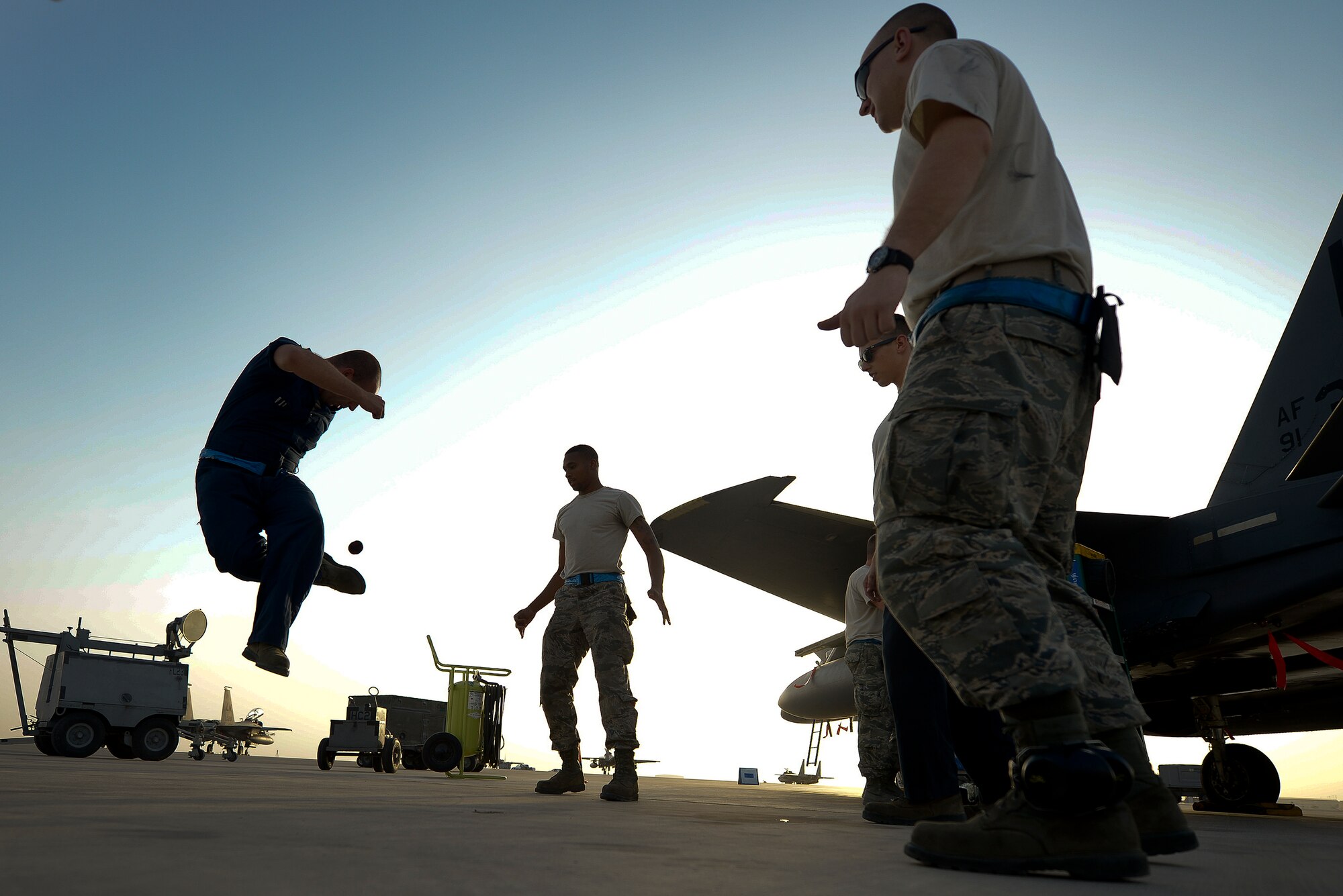 Tech. Sgt. Austin Becker, a 380th Expeditionary Aircraft Maintenance Squadron specialist expediter, plays hacky sack with other maintainers May 26, 2014, at an undisclosed location in Southwest Asia. Hacky sack is a longstanding maintenance tradition in deployed environments, helping to build morale and unit cohesion.  (U.S. Air Force photo byTech. Sgt. Russ Scalf/Released)