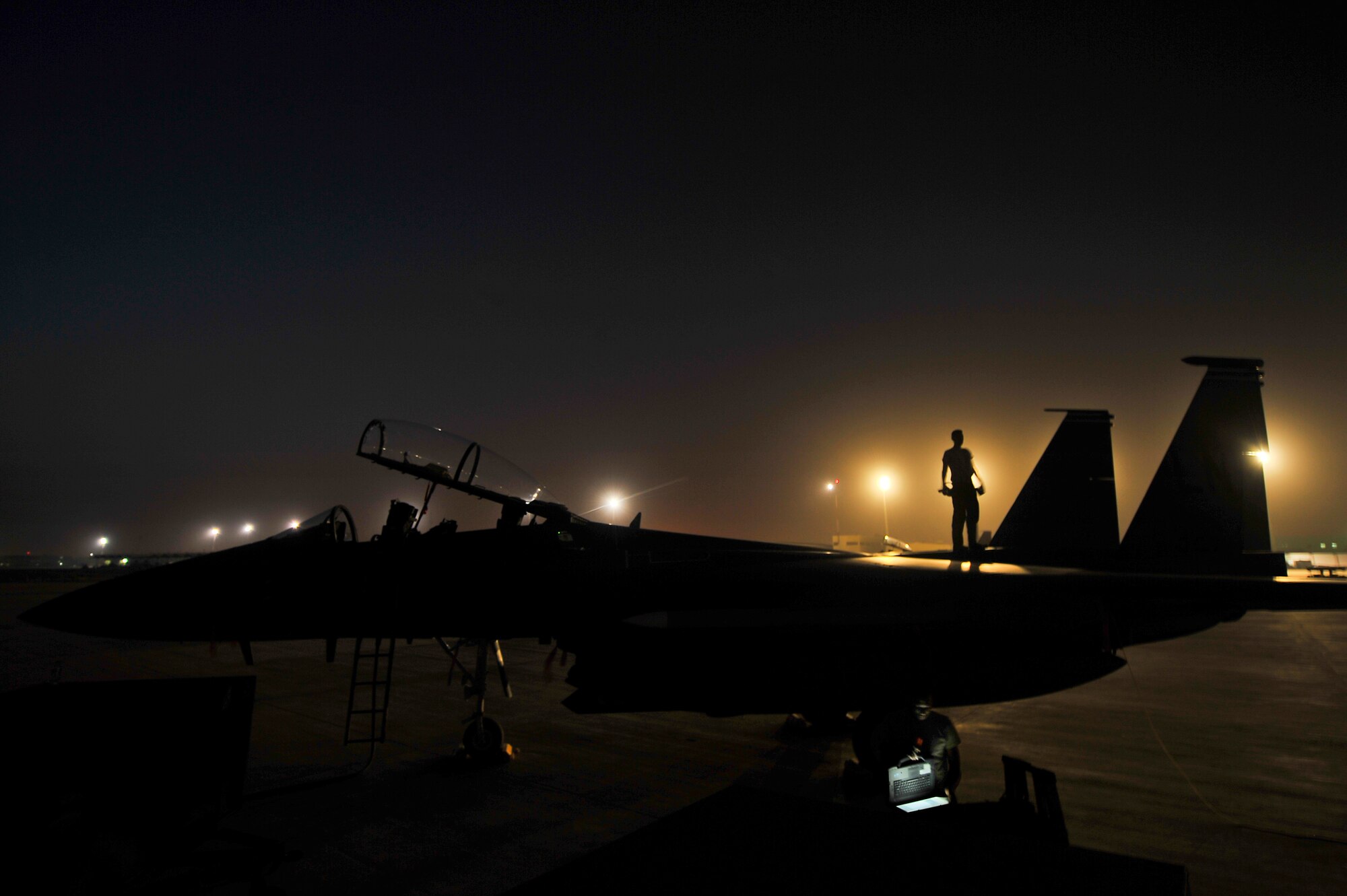 Airmen from the 380th Expeditionary Aircraft Maintenance Squadron troubleshoot an environmental control system issue on an F-15E Strike Eagle May 20, 2014, at an undisclosed location in Southwest Asia. Maintenance Airmen from the unit work around the clock to support combat operations. (U.S. Air Force photo byTech. Sgt. Russ Scalf/Released)