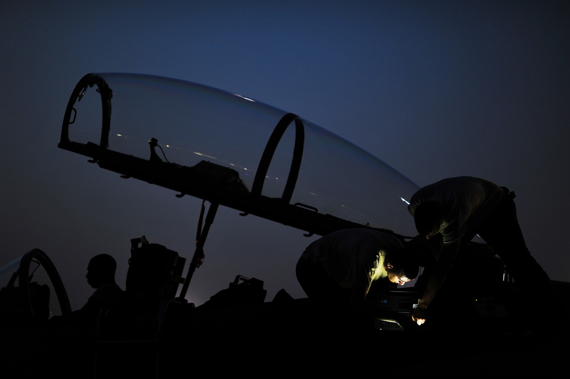 Airmen from the 380th Expeditionary Aircraft Maintenance Squadron troubleshoot an environmental control system issue on an F-15E Strike Eagle May 20, 2014, at an undisclosed location in Southwest Asia. Maintenance Airmen from the unit work around the clock to support combat operations. (U.S. Air Force photo byTech. Sgt. Russ Scalf/Released)