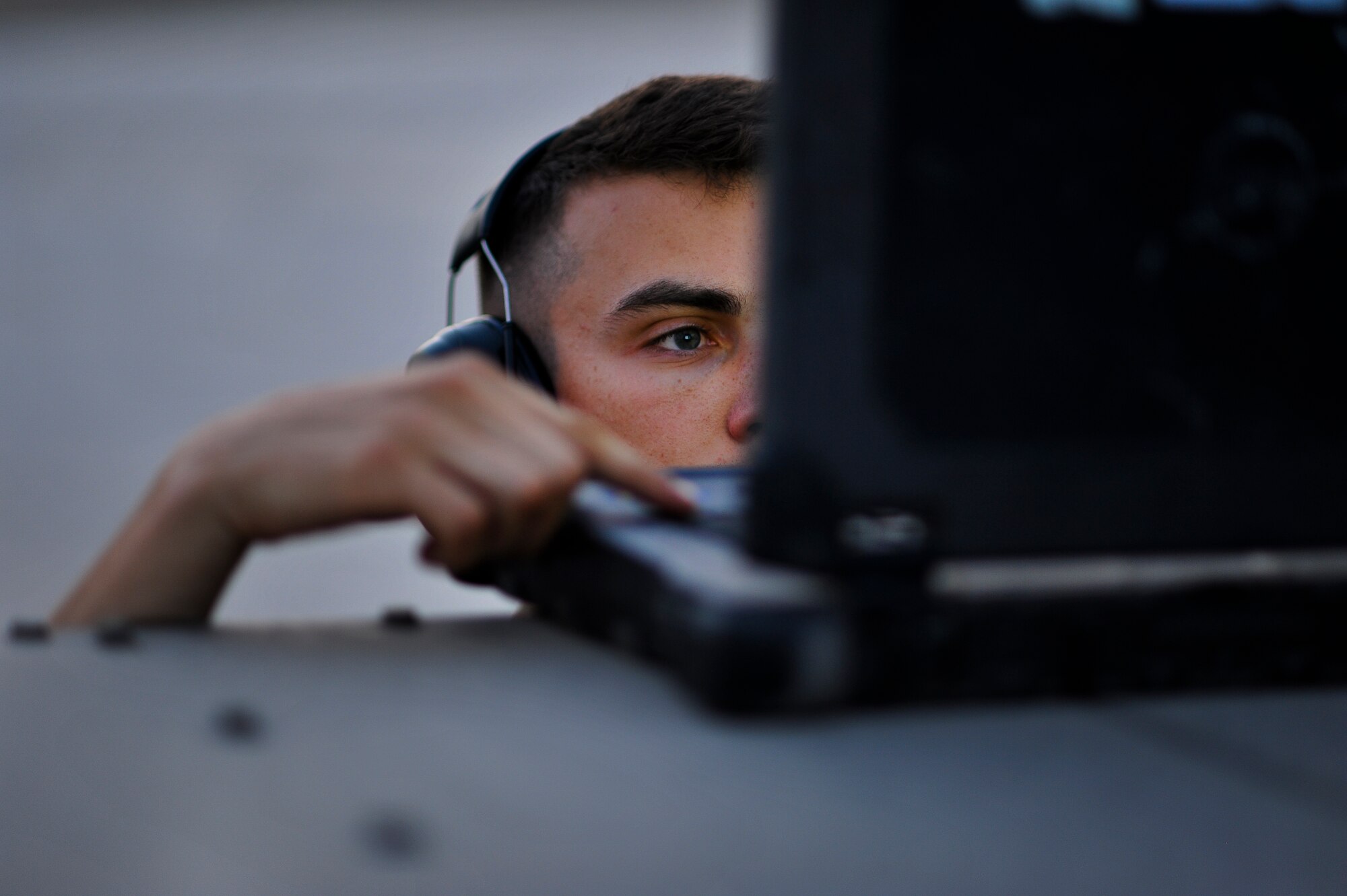 Airman Alexander McQueen, 380th Expeditionary Aircraft Maintenance Squadron, reviews a technical order May 20, 2014, at an undisclosed location in Southwest Asia. McQueen used the fault isolation manual to troubleshoot an environmental control system issue. (U.S. Air Force photo byTech. Sgt. Russ Scalf/Released)