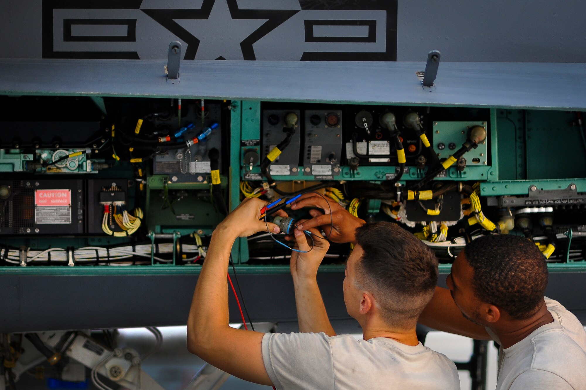 Airman Alexander McQueen and Airman 1st Class Dominique Dalton, 380th Expeditionary Aircraft Maintenance Squadron, troubleshoot the environmental control system on an F-15E Strike Eagle May 20, 2014, at an undisclosed location in Southwest Asia. The ECS controls cabin airflow and avionics cooling, providing comfort to the aircrew and keeps the avionics system functioning.  (U.S. Air Force photo byTech. Sgt. Russ Scalf/Released)