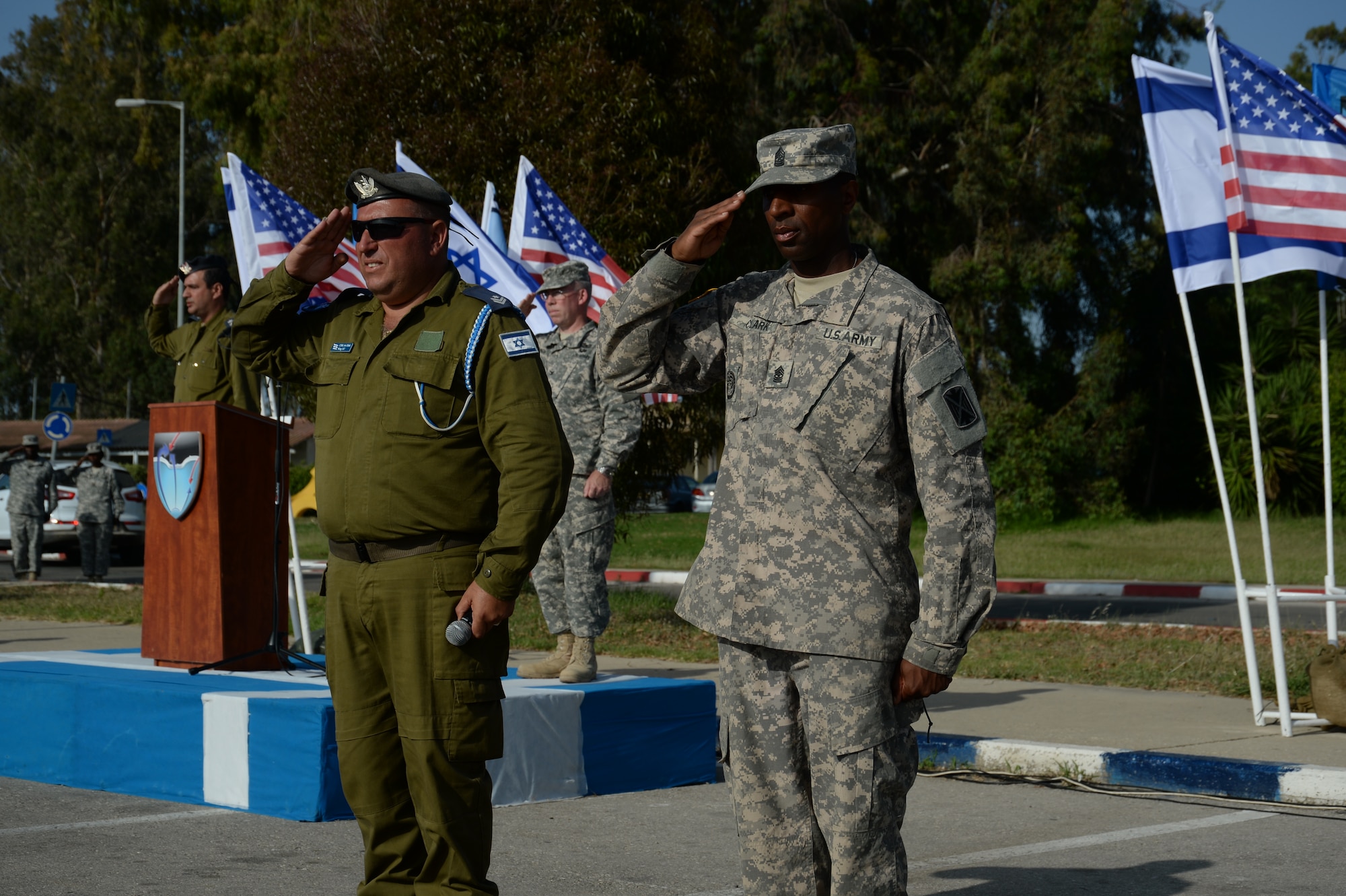 Israeli Defense Forces Command Sgt. Maj. Avraham Ifrach, command sergeant major of the Israeli 167th Active Defense Wing, left, and U.S. Army Sgt. Maj. George E. Clark, Jr., 10th Army Air Missile Defense Command operations sergeant major, right, salute during the closing parade ceremony of the bilateral Juniper Cobra 14 exercise at Hatzor Air Base, Israel, May 22, 2014. The specific focus of the JC14 is to improve combined defense capabilities and the overall interoperability of U.S. European command and the Israeli Defense Forces. (U.S. Air Force photo by Staff Sgt. Joe W. McFadden/Released)