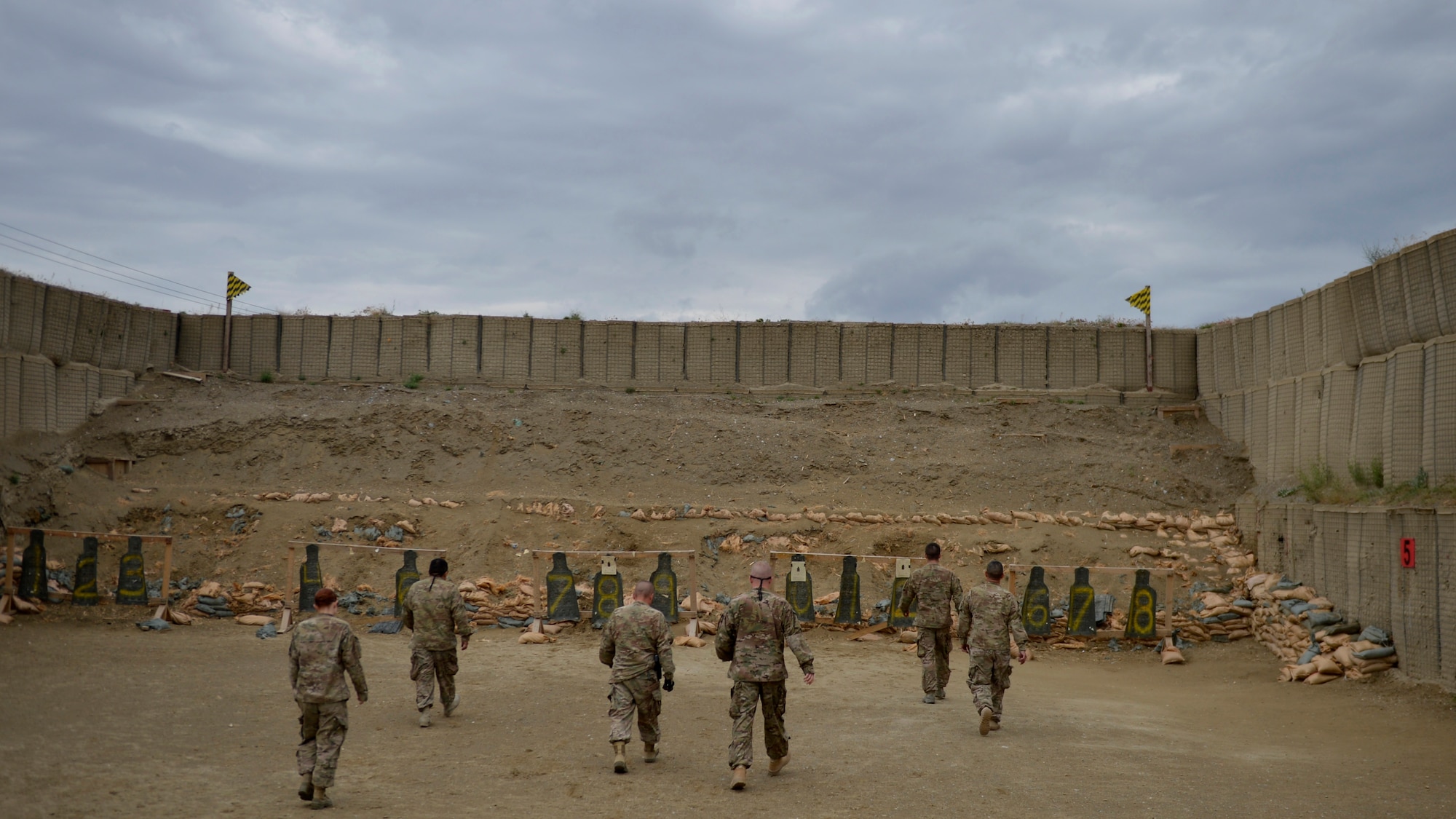 U.S. Airmen and Soldiers walk toward their targets after shooting their weapons on the firing range May 17, 2014 at Bagram Airfield, Afghanistan. 1Air Force combat arms training instructors provide support for the Army owned shooting range, they also fix and inspect Air Force weapons located in the airfield. (U.S. Air Force photo by Staff Sgt. Evelyn Chavez/Released)