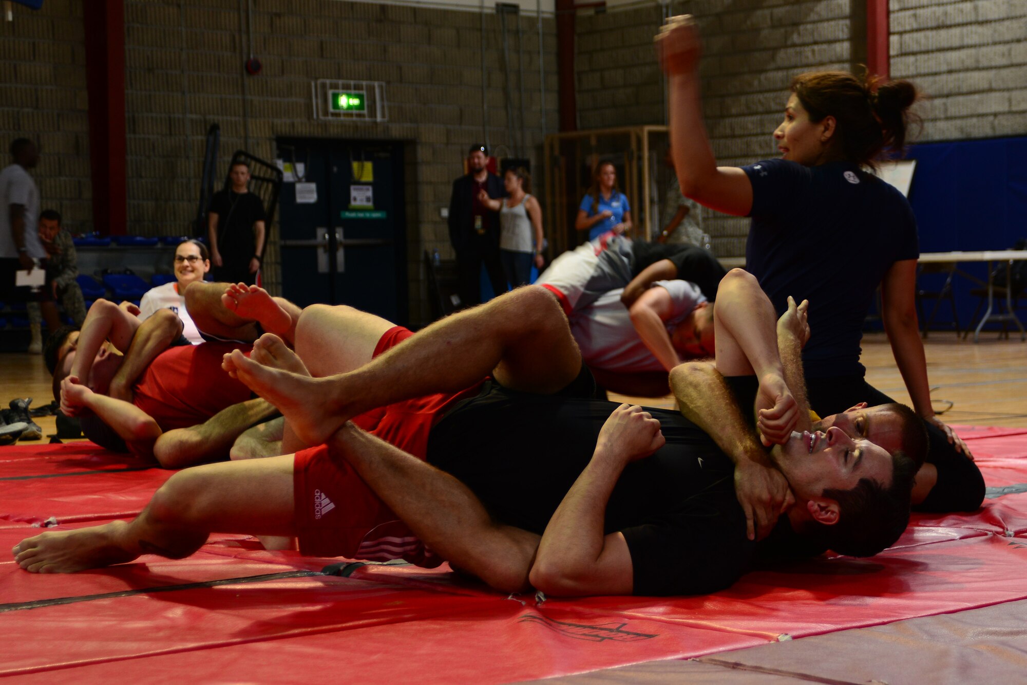 U.S. Service members practice Mixed Martial Arts at Al Udeid Air Base, Qatar, May 23, 2014.  The practice session was part of MMA fighters visiting the area of responsibility meeting, signing autographs and instructing on fighting techniques.  (U.S. Air Force Photo by Master Sgt. Marcelo Joniaux)     