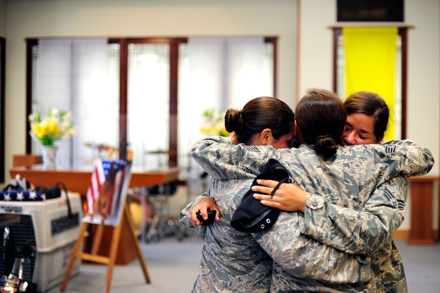 Members of the 8th Security Forces Squadron mourn during the memorial of military working dog Iian at Kunsan Air Base, Republic of Korea, May 21, 2014. (U.S. Air Force photo by Senior Airman Taylor Curry/Released)