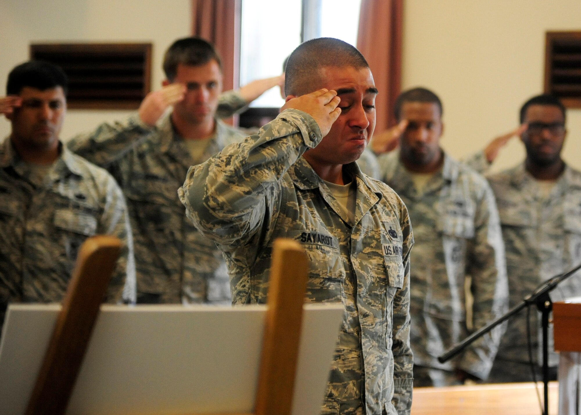 Staff Sgt. Daniel Sayarot, 8th Security Forces Squadron military working dog handler, renders a salute during the memorial of his dog Iian at Kunsan Air Base, Republic of Korea, May 21, 2014. Sayarot stated that Iian was the best MWD he had ever had the honor to work with. (U.S. Air Force photo by Senior Airman Taylor Curry/Released)