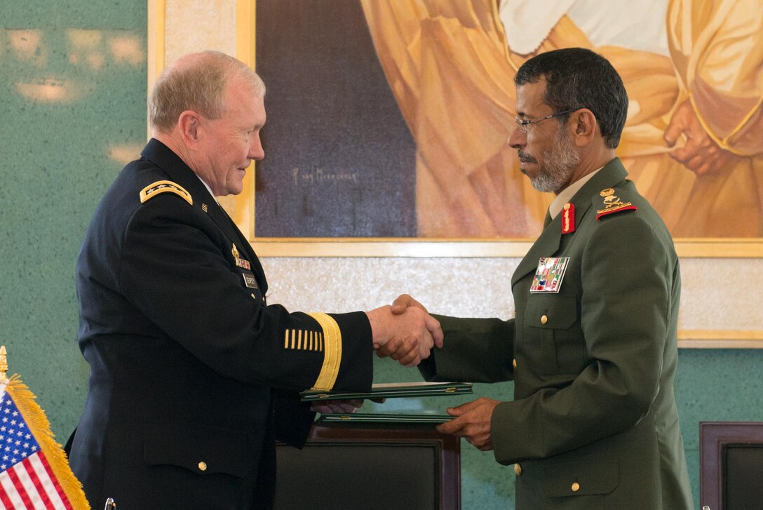 U.S. Army Gen. Martin E. Dempsey, left, chairman of the Joint Chiefs of Staff, and Army Lt. Gen. Hamad Thani al-Rumaithi, chief of staff of United Arab Emirates’ armed forces, 
shake hands after signing a security agreement in Abu Dhabi, United Arab Emirates, May 28, 2014.