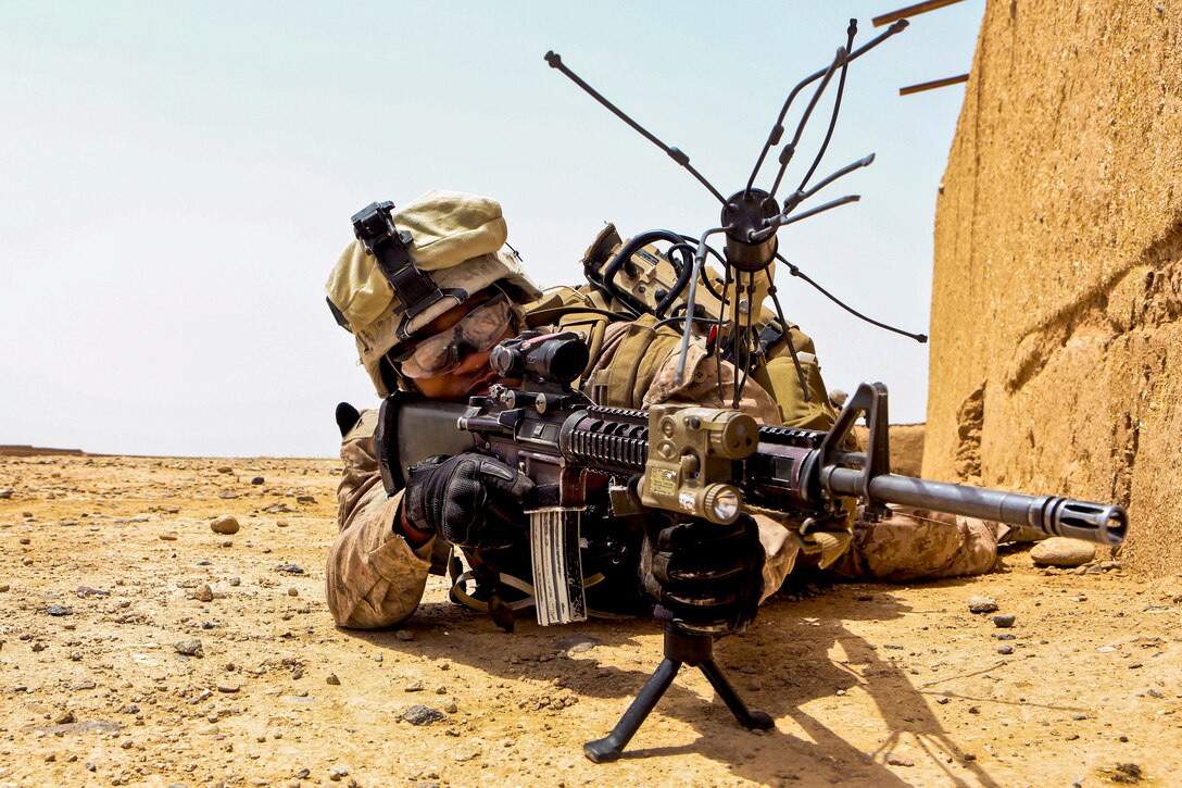 U.S. Marine Corps Lance Cpl. Jean Vil provides security from a prone position during a reconnaissance patrol near Patrol Base Boldak in Helmand province, Afghanistan, May 15, 2014. Vil, a mortarman, is assigned to Charlie Company, 1st Battalion, 2nd Marine Regiment.
