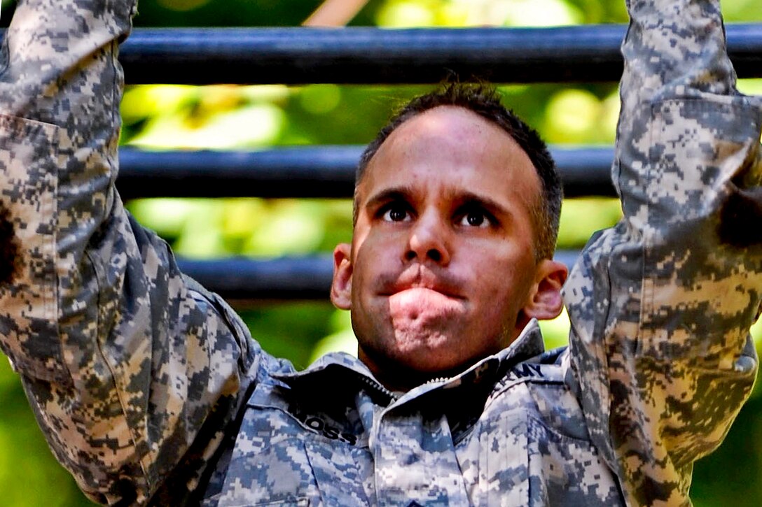 Army Staff Sgt. Jarod Moss navigates the horizontal ladder obstacle on the confidence course during the annual Drill Sergeant of the Year competition on Fort Eustis, Va., June 27, 2012.  
