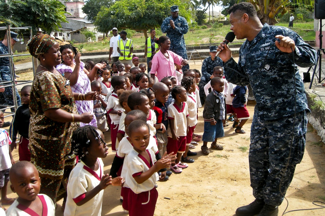 U.S. Navy Petty Officer 2nd Class Kori Gillis sings with children at Centro Infantil Santa Margarida during an Africa Partnership Station 2012 event in Nacala, Mozambique, June 21, 2012. Africa Partnership Station is an international security cooperation initiative, facilitated by Commander, U.S. Naval Forces Africa, to strengthen global maritime partnerships through training and collaborative activities.  
