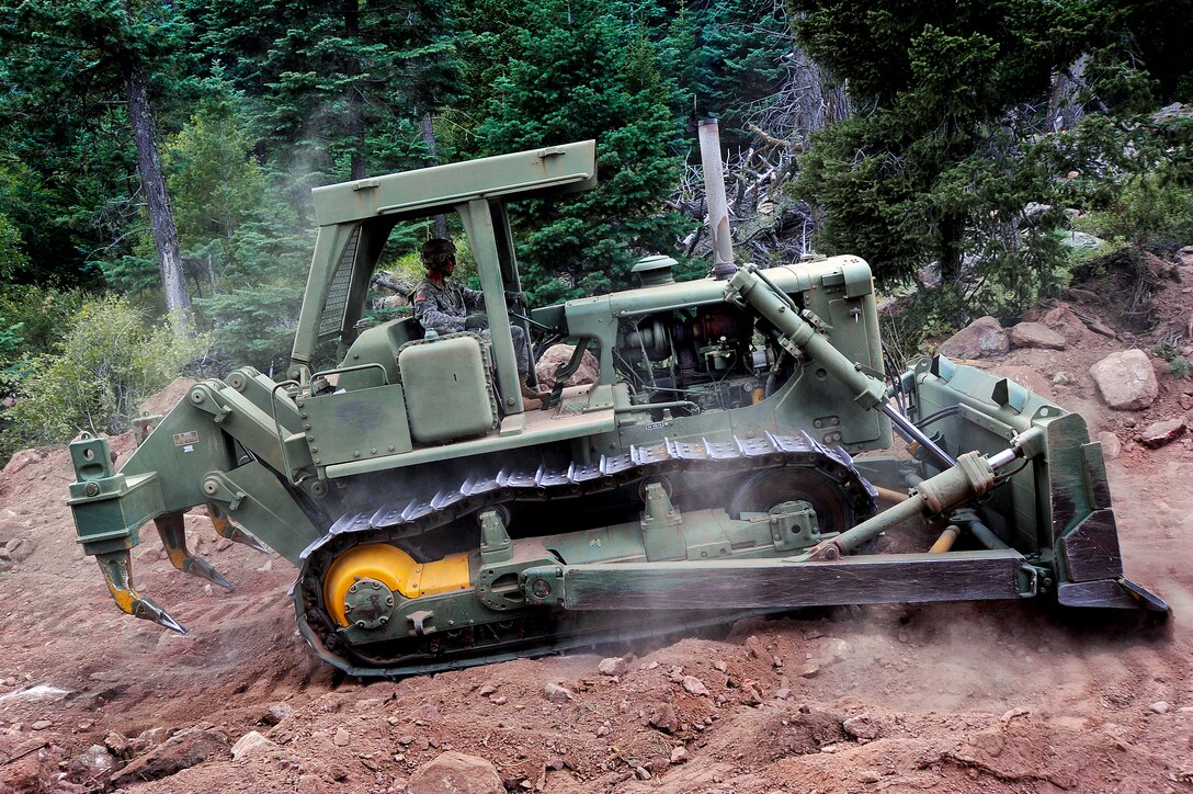 Army Command Sgt. Maj. Ronald G. Patterson builds a firebreak along a mountainside near the U.S. Air Force Academy in Colorado Springs, Colo., June 28, 2012. Patterson is assigned to the 52nd Engineering Battalion.  
