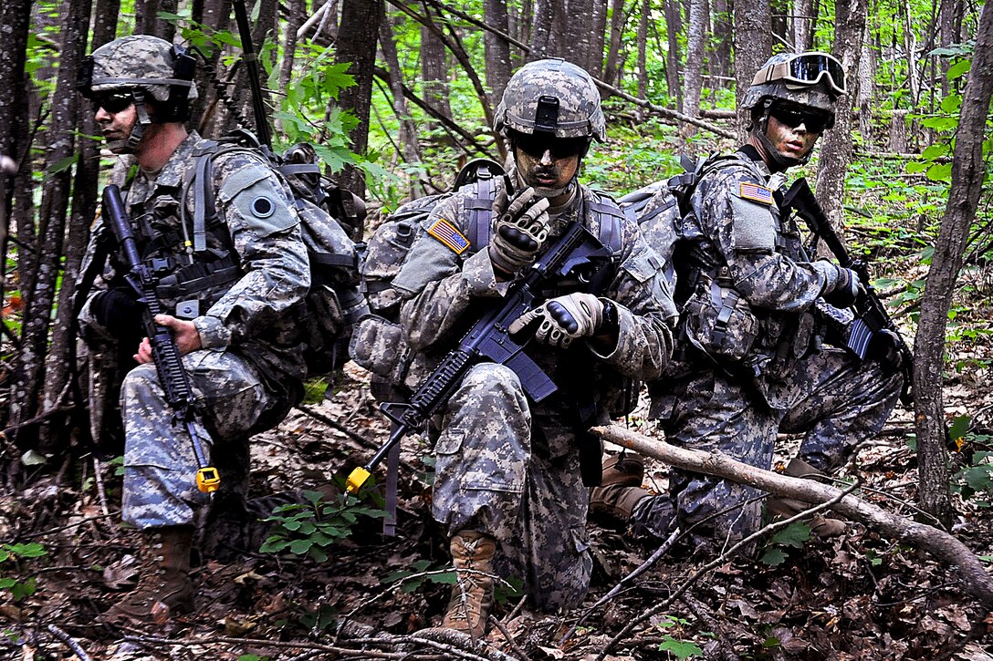 A soldier uses his hand held radio to give a situation report to members of his company while other soldiers provide security during a dismounted foot patrol after an air assault training mission on Camp Grayling, Mich., June 20, 2012. The soldiers are assigned to the 1st Battlion, 125 Infantry, Michigan Army National Guard.  
