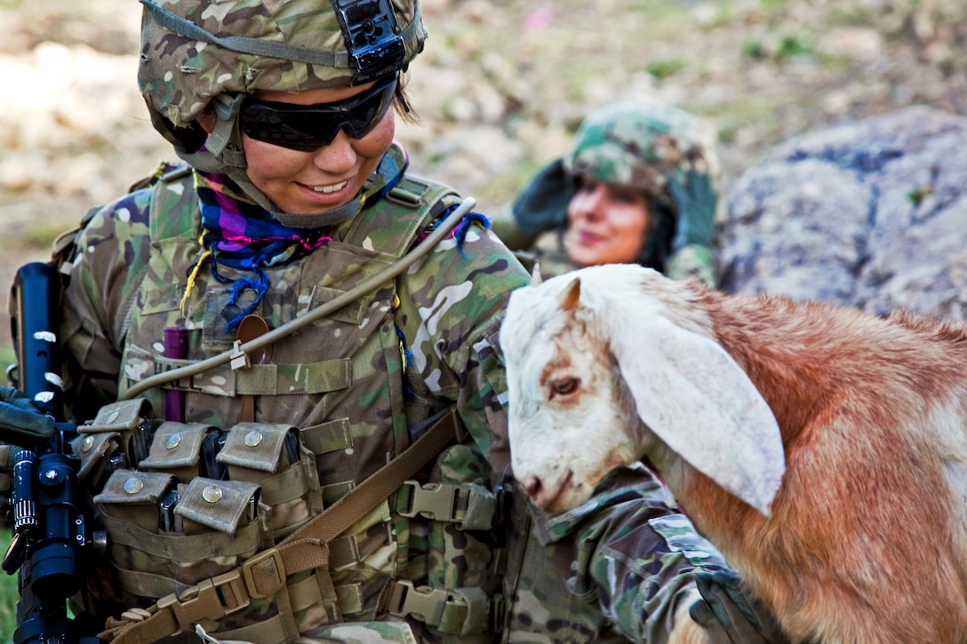 U.S. Army Spc. Samantha Hall pets a goat during a patrol in Loy Murghoz in Afghanistan's Khowst province, June 8, 2012. Hall is assigned to 2nd Battalion, 377th Parachute Field Artillery Regiment.  
