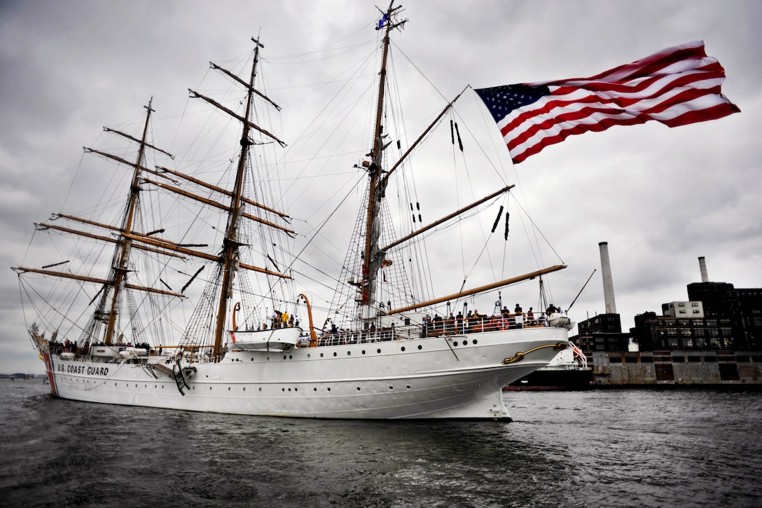 The Coast Guard Cutter Eagle, America's Tall Ship, passes the Domino Sugar plant as it departs the Baltimore Harbor, June 17, 2012, to continue its participation in OpSail 2012. The Eagle is an 1,800-ton steel hull, three-masted sailing ship with more than 21,000 square-feet of sail and more than five miles of rigging.  
