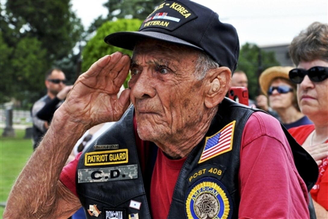 C.D. Studyvin, a veteran of World War II and the Korean War, salutes the U.S. flag during a Memorial Day ceremony at El Paso Cemetery in Derby, Kan., May 26, 2014. Members of the local American Legion and Veterans of Foreign Wars organizations conducted the ceremony, which drew veterans like Studyvin. 