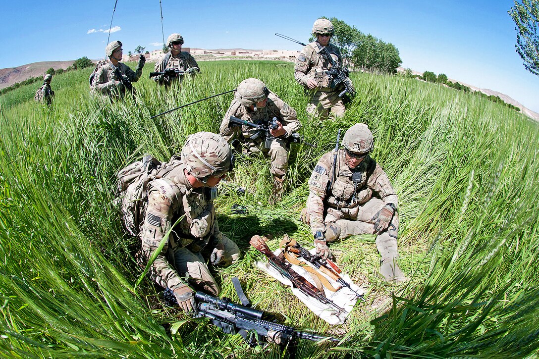 U.S. Army paratroopers discover a weapons cache while sweeping a remote mountain village in Afghanistan's Ghazni province, June 3, 2012. The soldiers are assigned to the 82nd Airborne Division's 1st Brigade Combat Team. The village is a suspected Taliban safe haven.  
