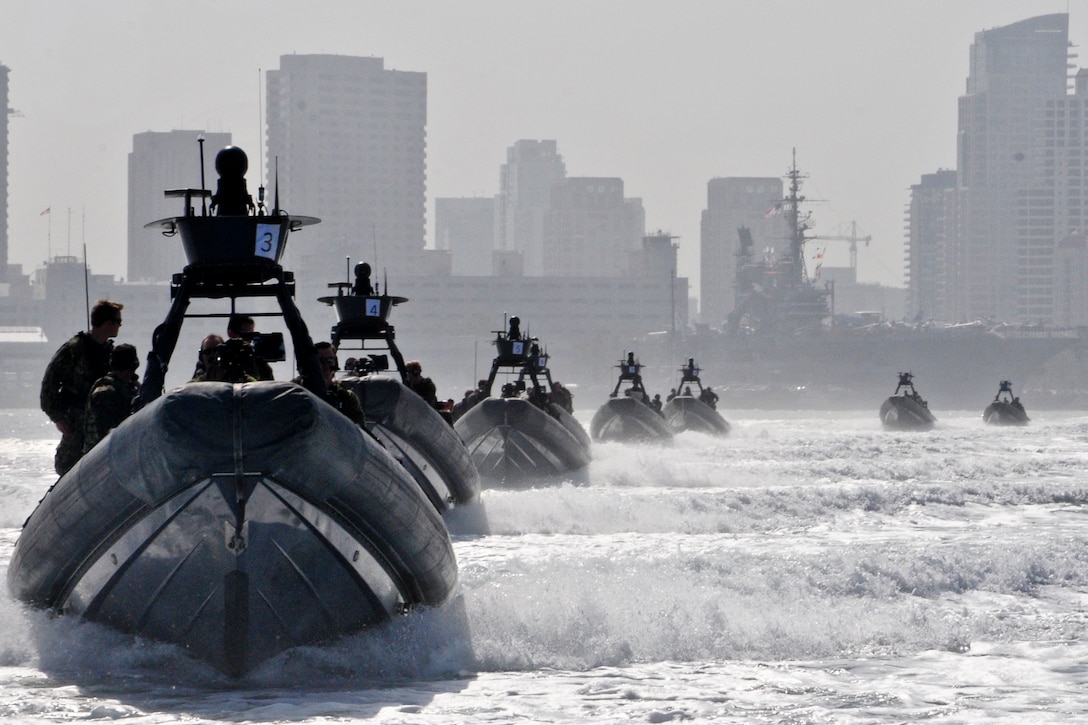 Rigid-hull inflatable boats carry guests and sailors assigned to Special Boat Team 12 through San Diego Bay to an at-sea change of command in San Diego, June 7, 2012.  
