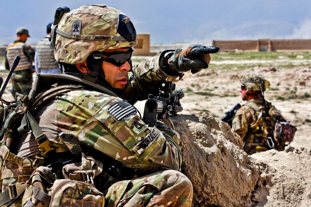 U.S. Army Sgt. 1st Class Fernando Gonzalez directs the movement of his platoon outside Combat Outpost Zormat in Afghanistan's Paktya province, May 30, 2012. Gonzales is assigned to the 25th Infantry Division's Company D, 3rd Battalion, Airborne, 509th Infantry Regiment.  
