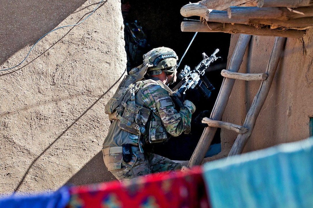 A U.S. paratrooper searches a suspected insurgent compound during a combat operation in Afghanistan's Ghazni province, June 2, 2012. The soldier is assigned to the 82nd Airborne Division’s 1st Brigade Combat Team.  
